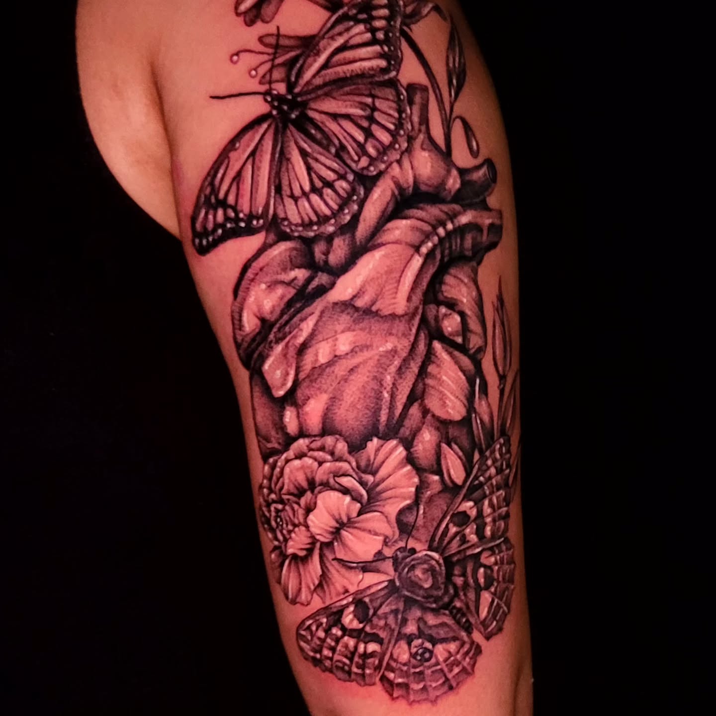 Butterfly and flower realism tattoo on the forearm by Tyler Monty
