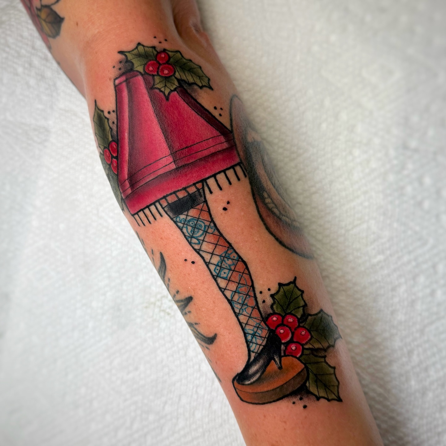 Christmas-themed high heel American traditional tattoo on the forearm by ๐ ๐ต๐๐๐๐๐ ๐ฎ๐๐๐๐๐๐๐๐๐