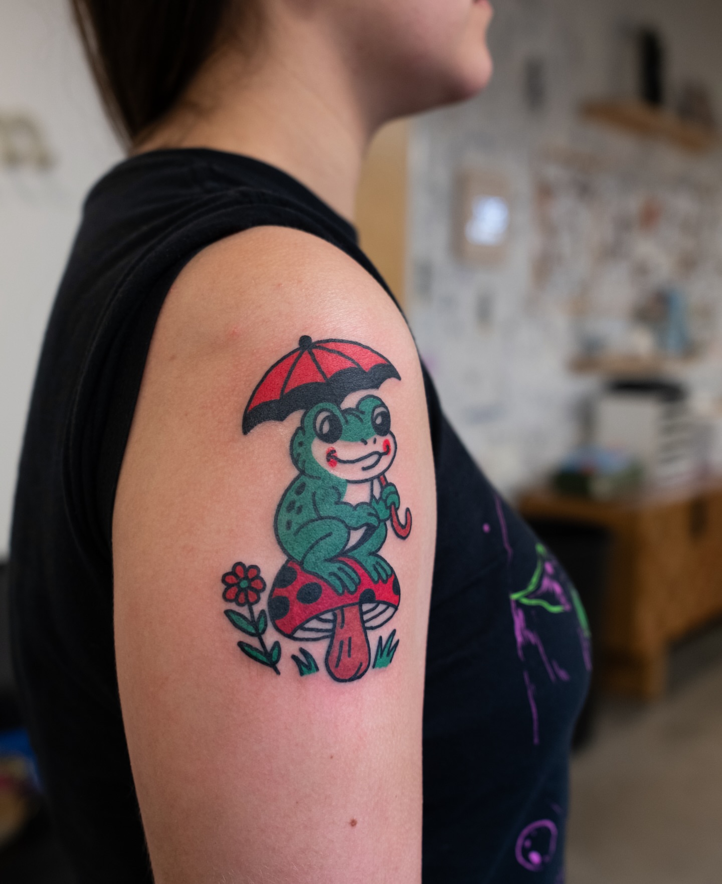 Frog with umbrella American traditional tattoo on the upper arm by Neto Velasco - Sad Cat Tattoo, Austin, Texas