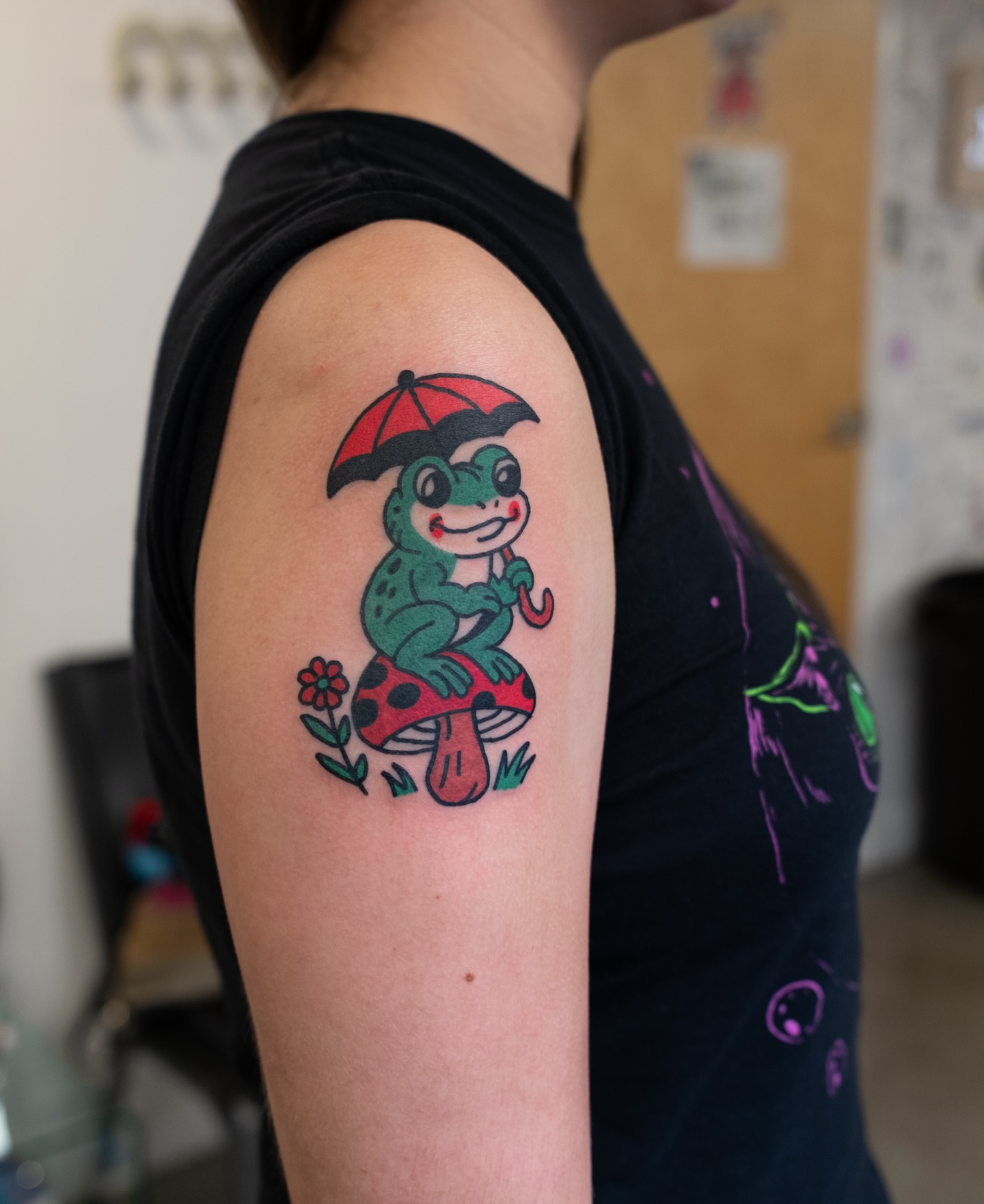 Frog on mushroom new school tattoo on the upper arm by Neto Velasco - Sad Cat Tattoo, Austin, Texas