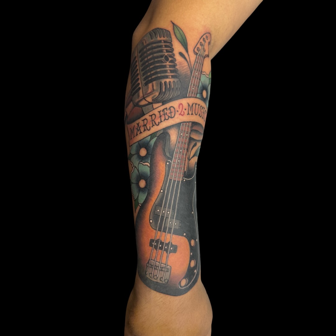 Electric guitar and microphone American traditional tattoo on the forearm by Victor Campos