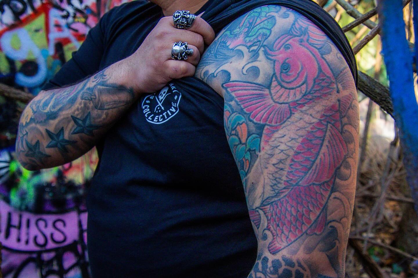 Koi fish japanese irezumi tattoo on the upper arm by Dave Robinowitz