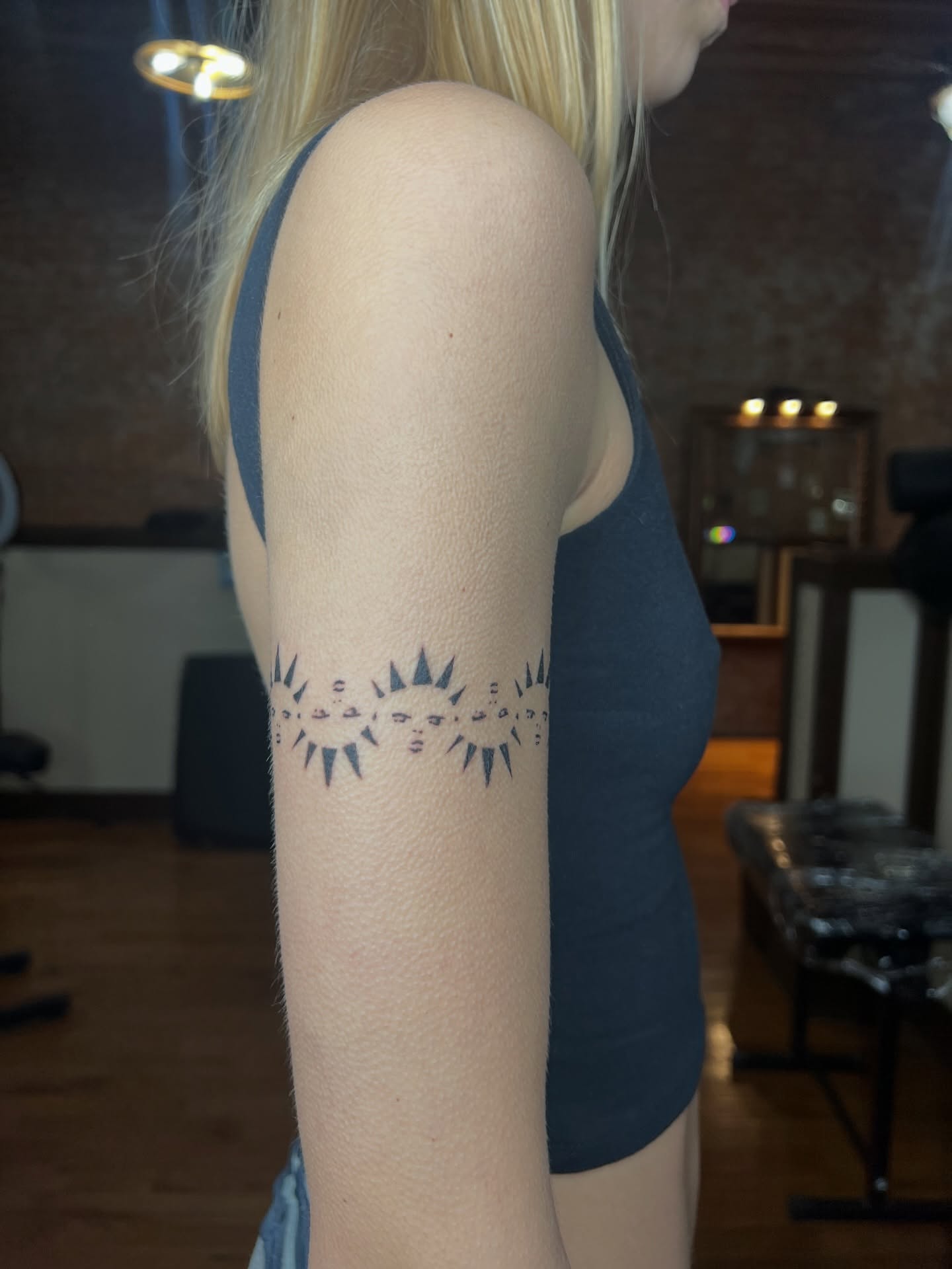 Sunburst geometric tattoo on the forearm by Meghan B