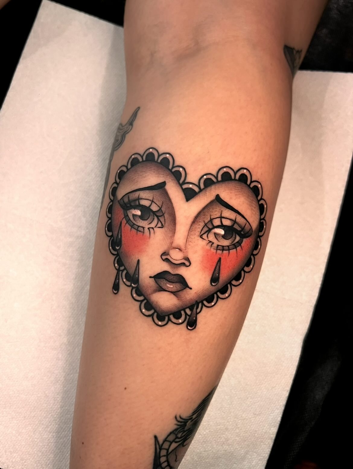 Heart-shaped face American traditional tattoo on the forearm by 𝙻𝚒𝚊 𝙹𝚎𝚙𝚙𝚎𝚜𝚎𝚗