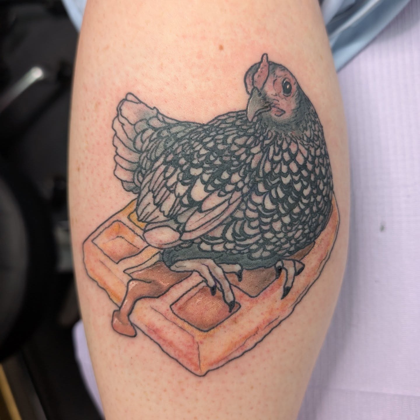 Chicken on waffle realism tattoo on the forearm by Trinity Renee