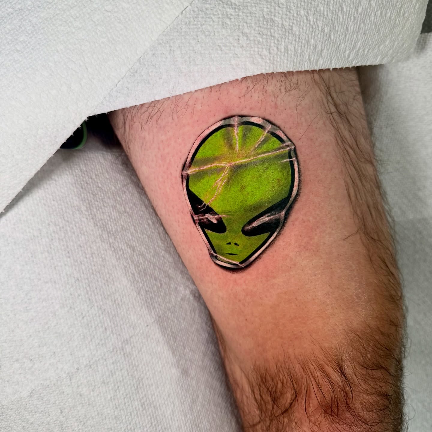 Alien head realism tattoo on the forearm by Tatum