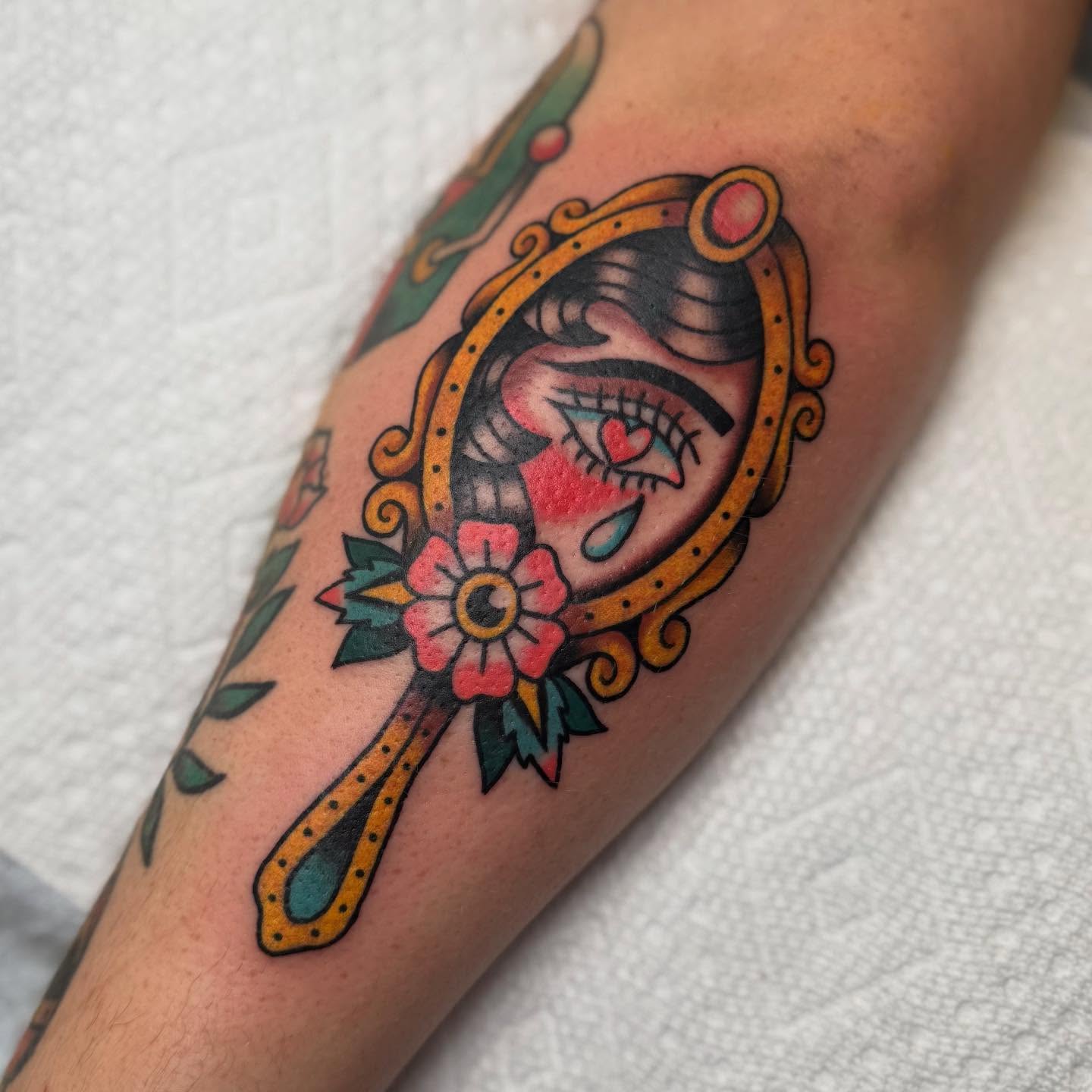 Mirror reflection American traditional tattoo on the forearm by Elle Yax