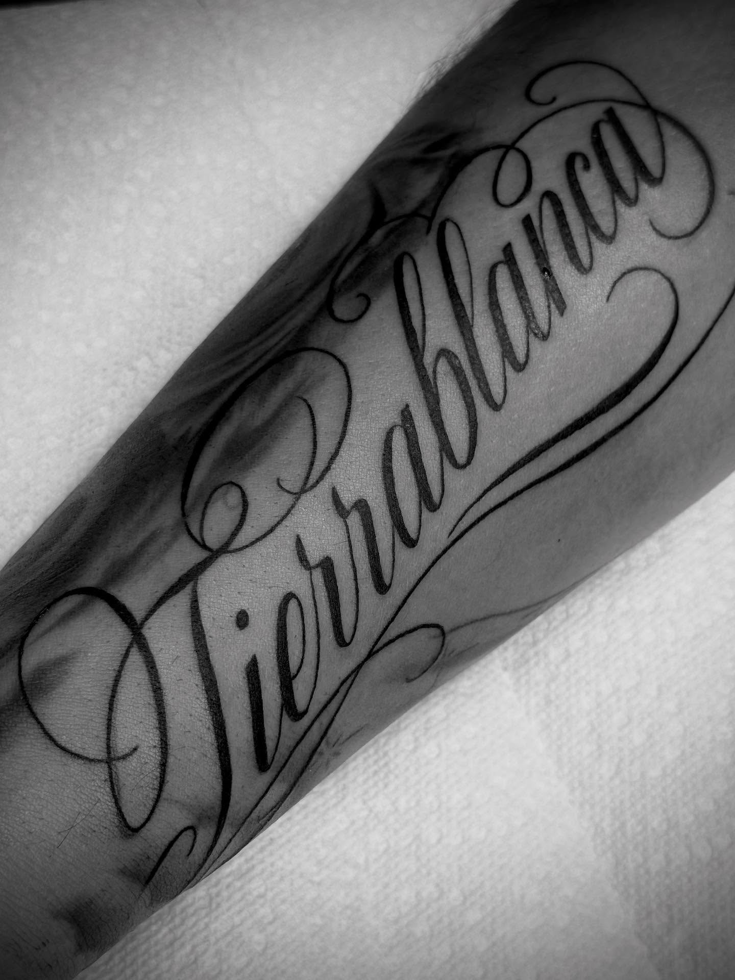 Sierrablanca lettering script tattoo on the forearm by Jameson William Cowan
