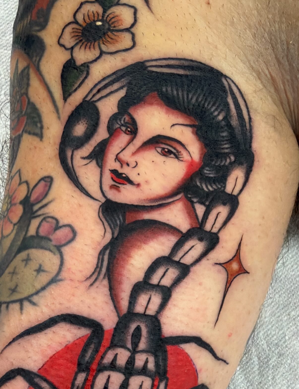 Woman with chain American traditional tattoo on the forearm by David Evans