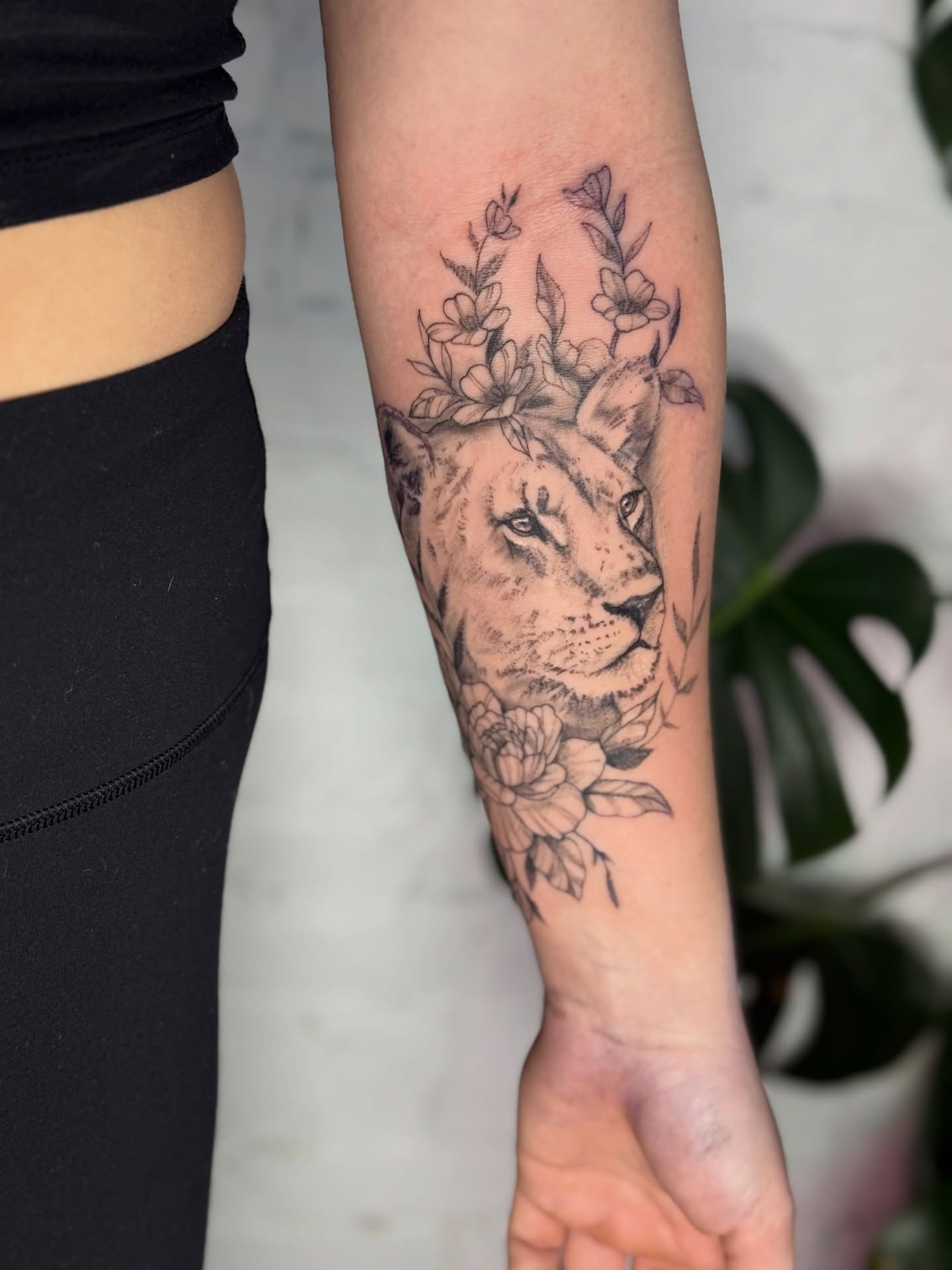 Lion with floral crown realism tattoo on the forearm by Asia Rene Tattoos👑