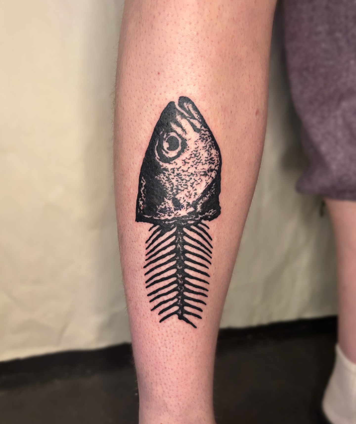 Fish skeleton black and grey tattoo on the forearm by Cooper, Portland, Oregon