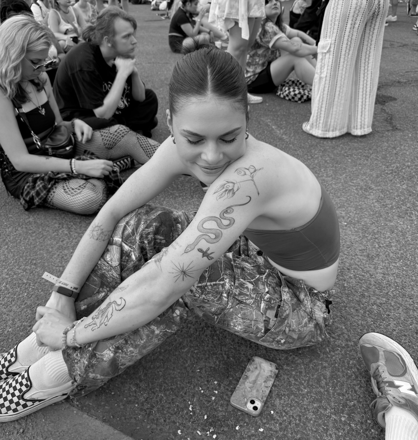 Snake and flower black and grey tattoo on the upper arm by Sarah