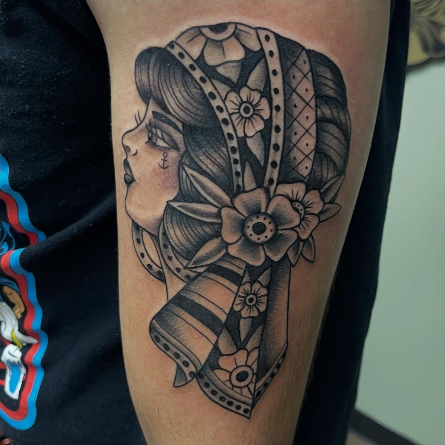 Woman with floral headdress American traditional tattoo on the forearm by Tina Gregg, North Ridgeville, Ohio