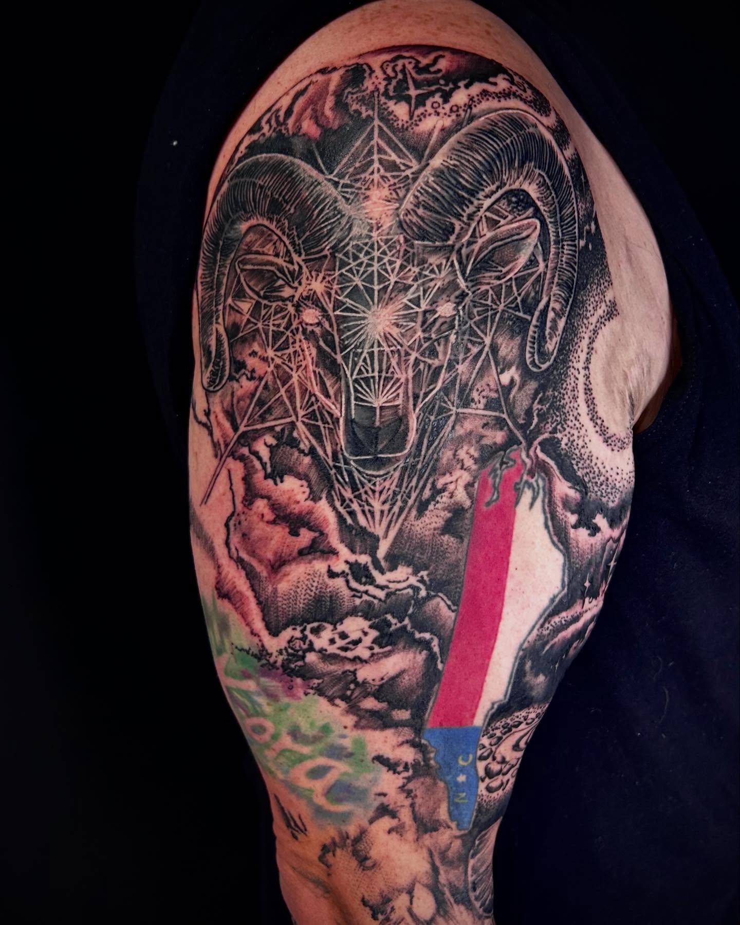 Ram head geometric tattoo on the shoulder by Jon Byrd