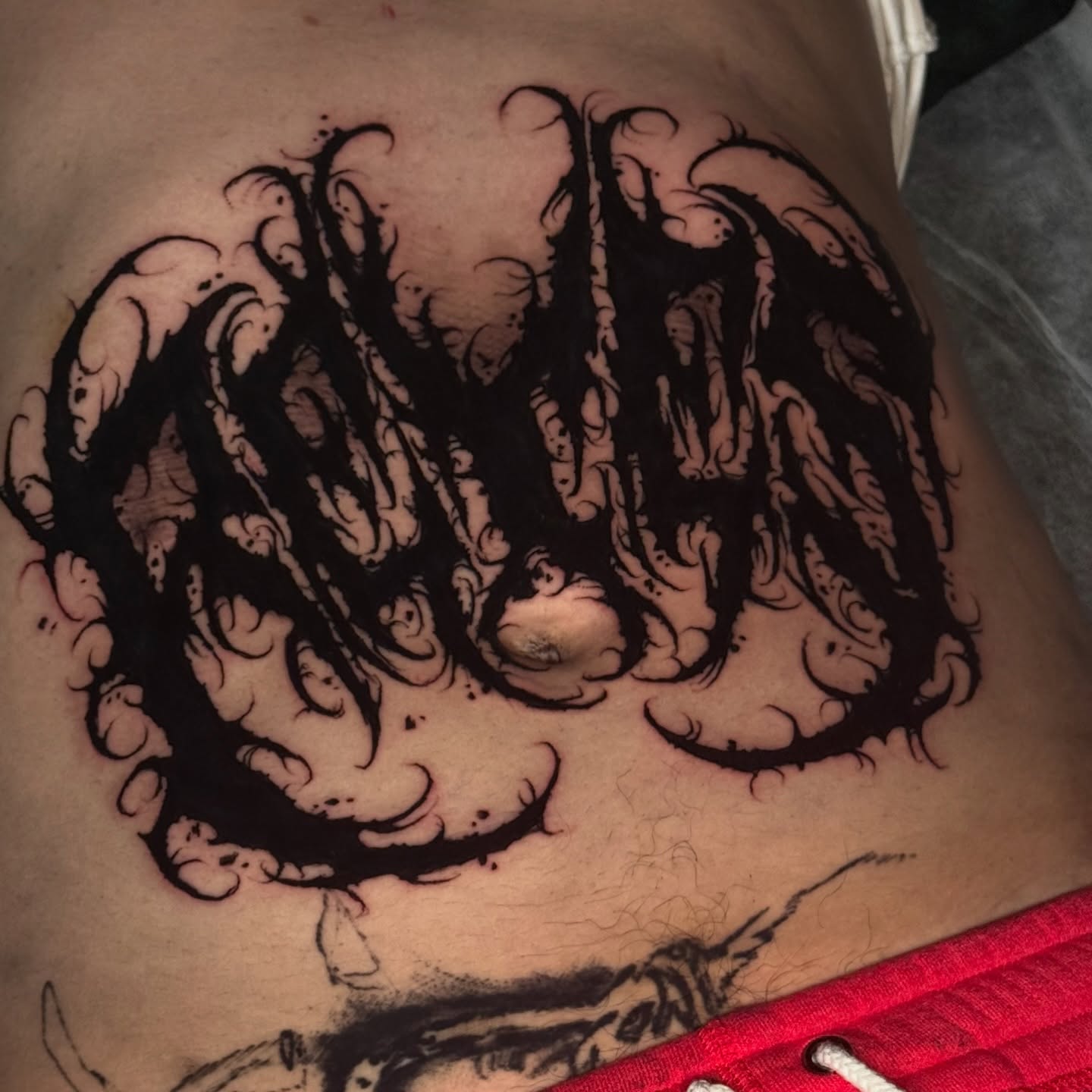 Abstract waves black and grey tattoo on the ribs by Isaac
