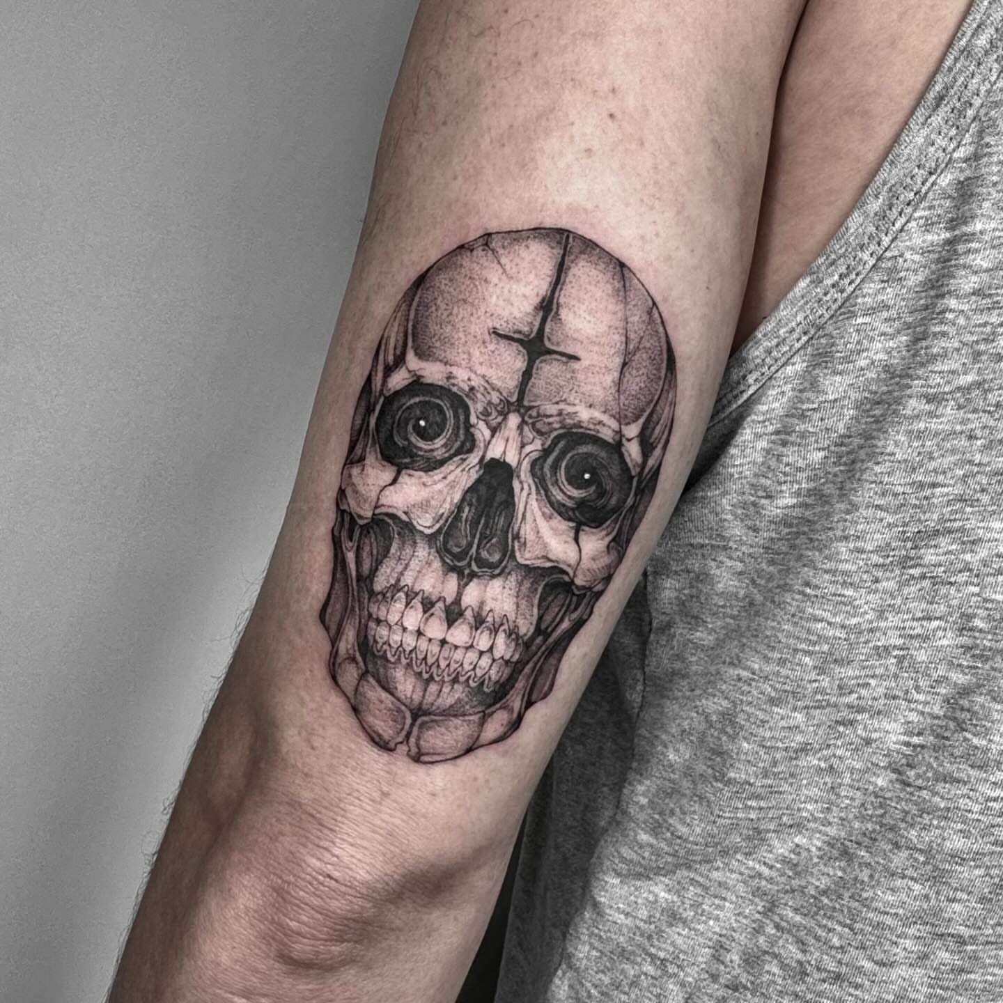 Skull dotwork tattoo on the forearm by taline