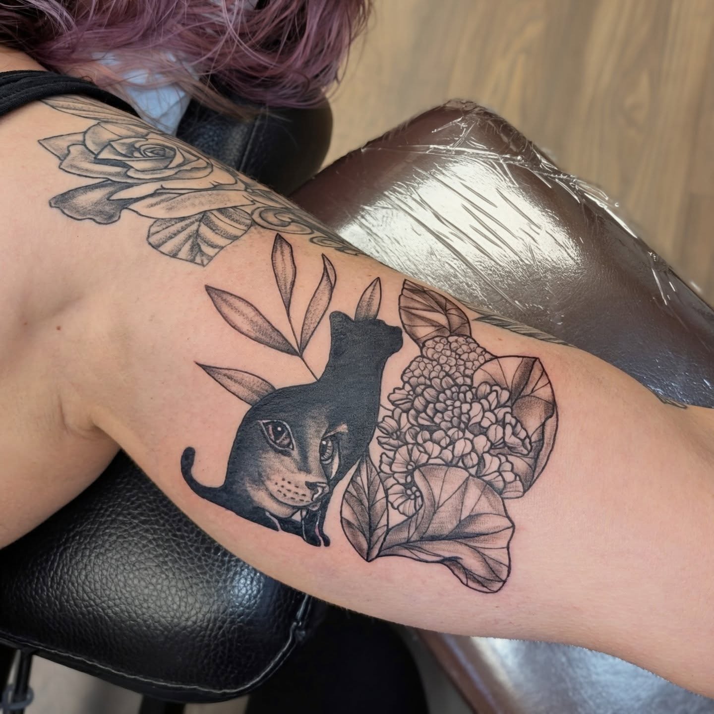 Cat and hydrangea realism tattoo on the forearm by Devon Ward, Portland, Oregon