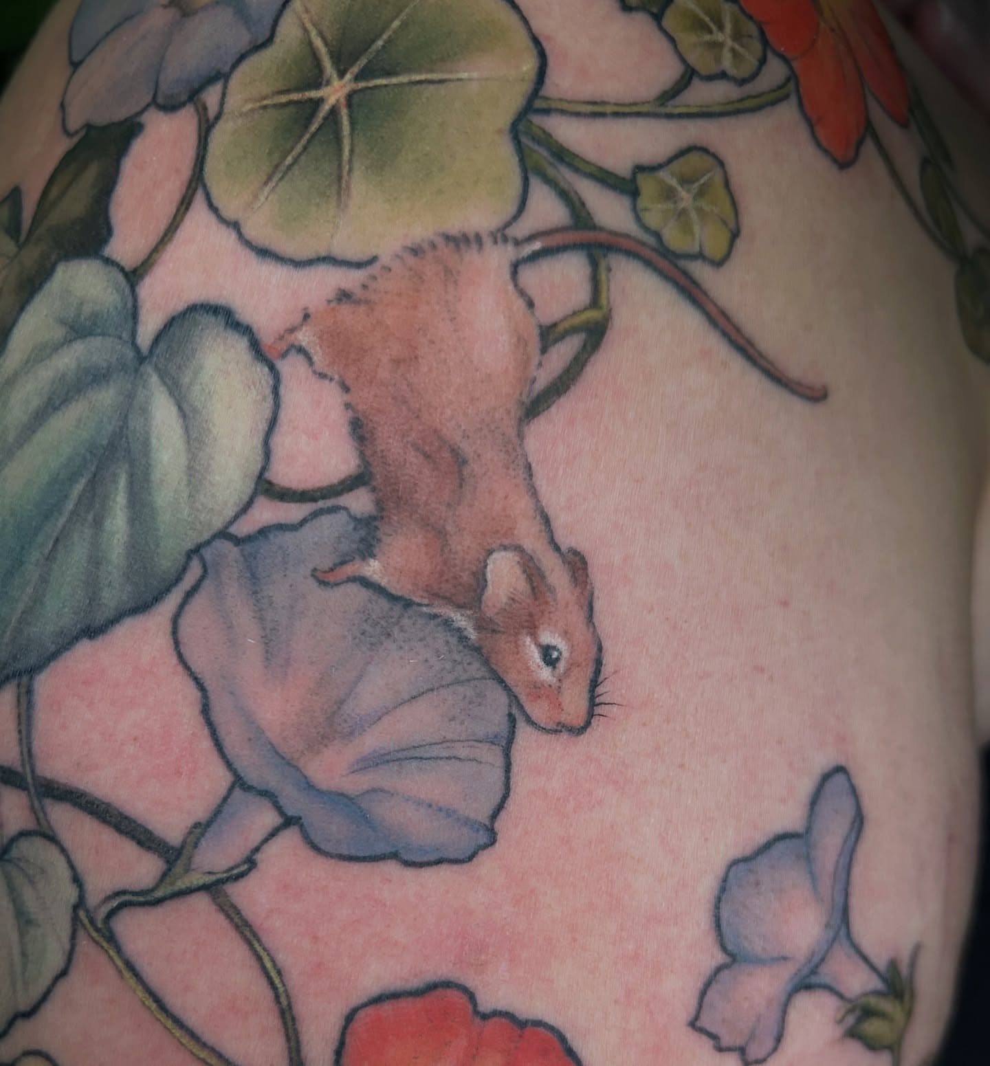 Mouse and leaves watercolor tattoo on the upper arm by Amber Miracle