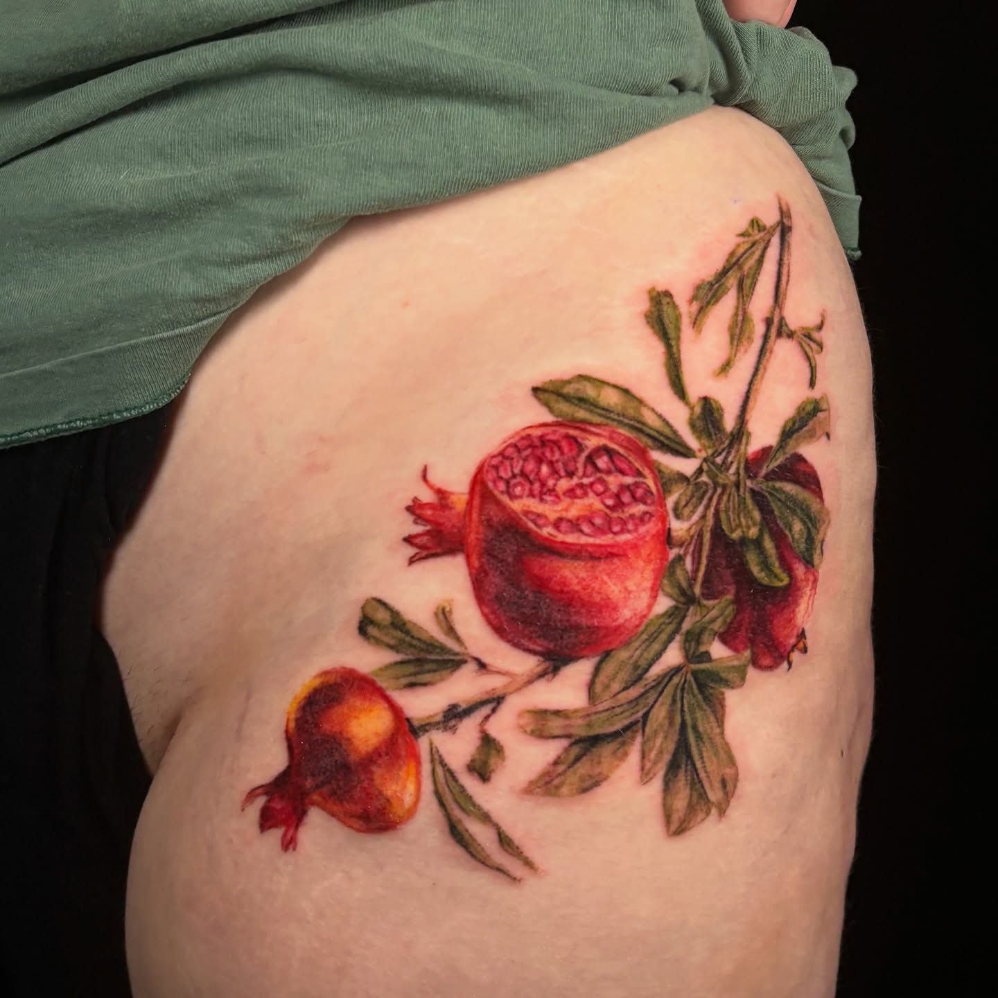 Pomegranate realism tattoo on the thigh by jordy