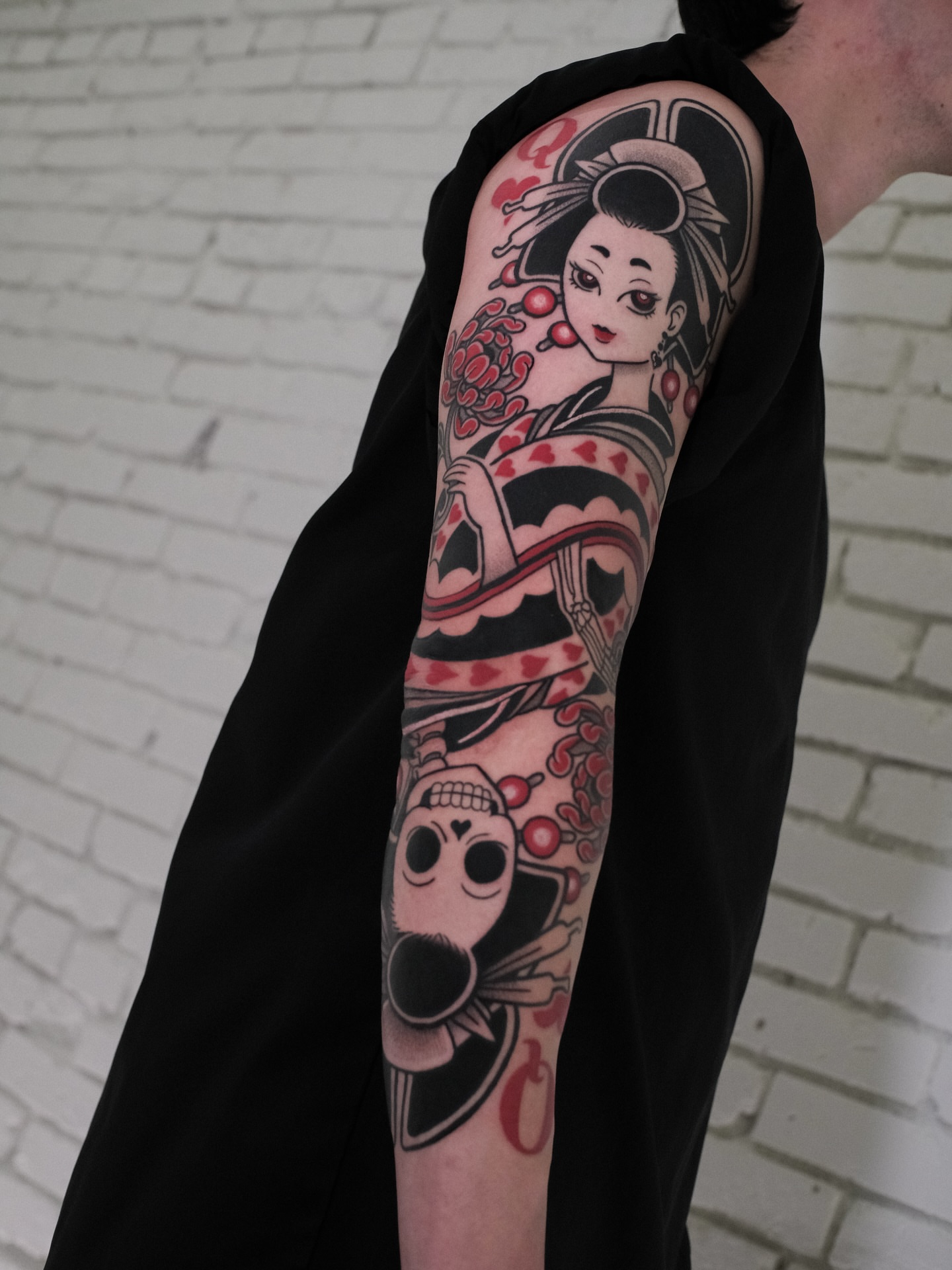 Geisha and skull American traditional tattoo on the upper arm by seattle tattoo artist