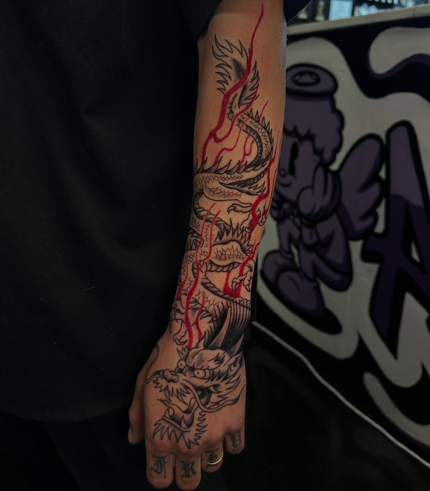 Dragon American traditional tattoo on the forearm by Angel Tattoos