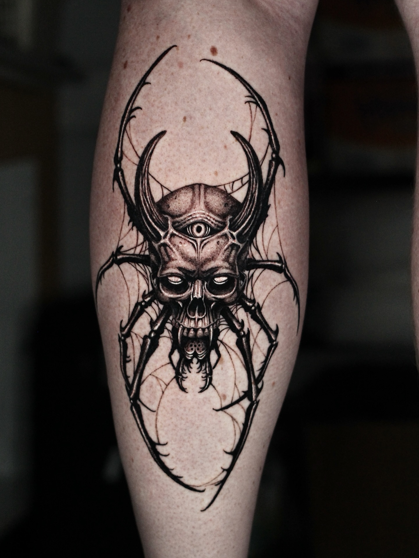 Skull with horns dark realism tattoo on the forearm by H.black