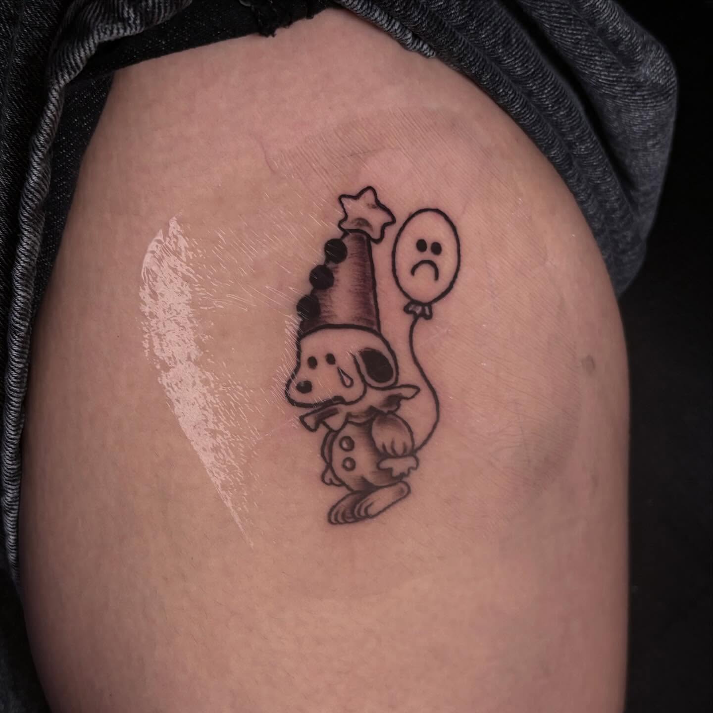 Sad clown black and grey tattoo on the thigh by Angel Arceo