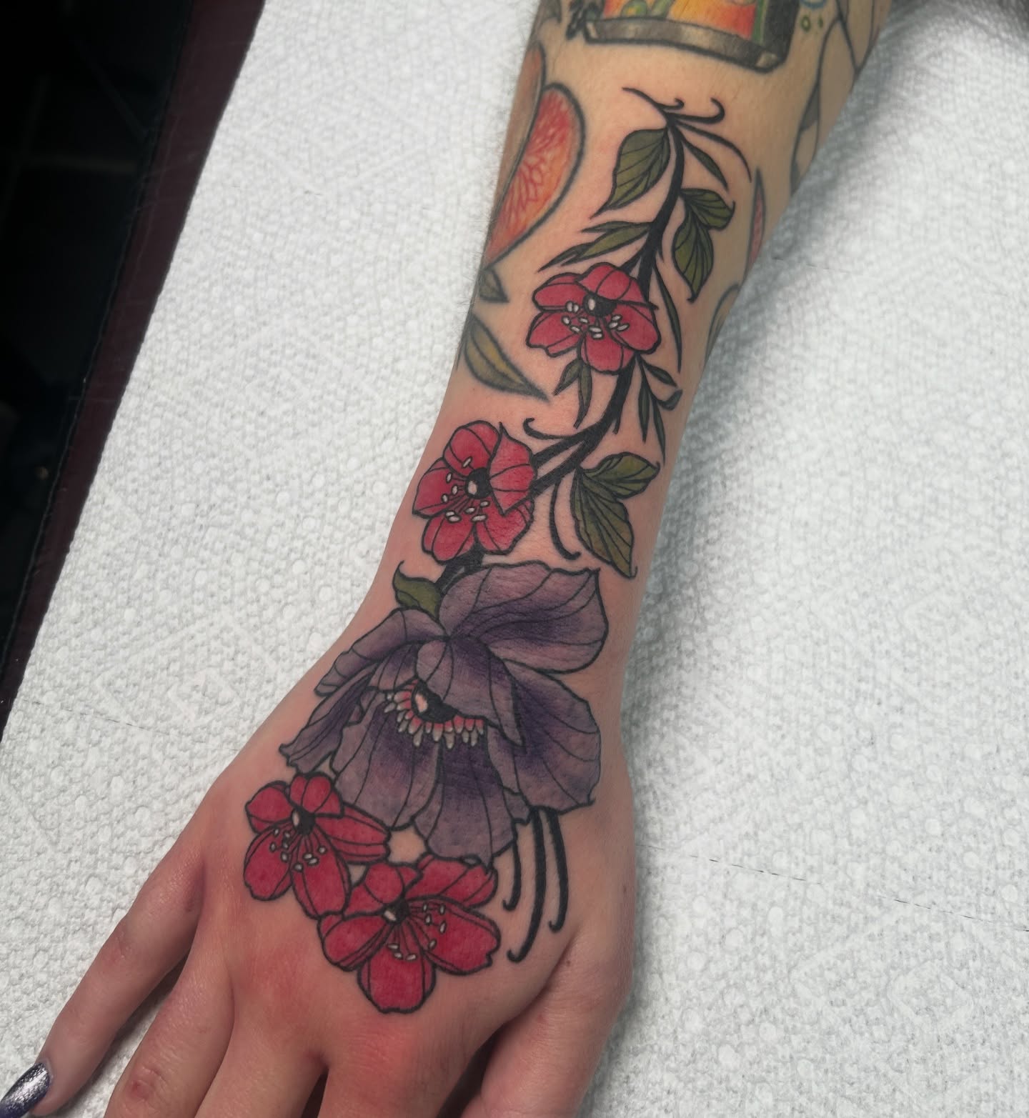 Floral arrangement American traditional tattoo on the forearm by Dylan James