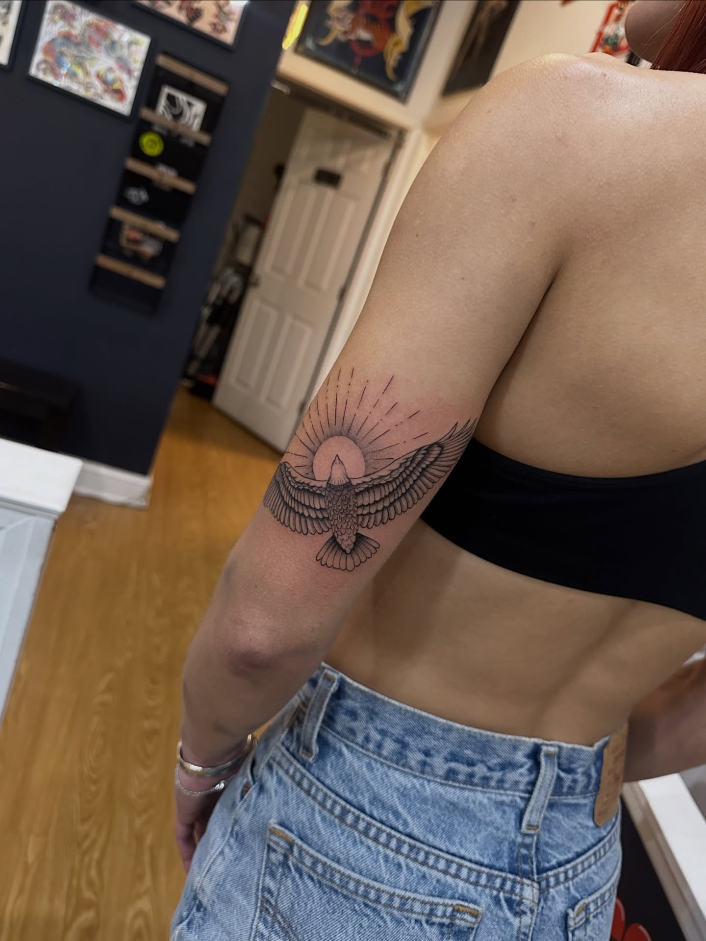 Bird with sun neo-traditional tattoo on the forearm by Matt Kearney