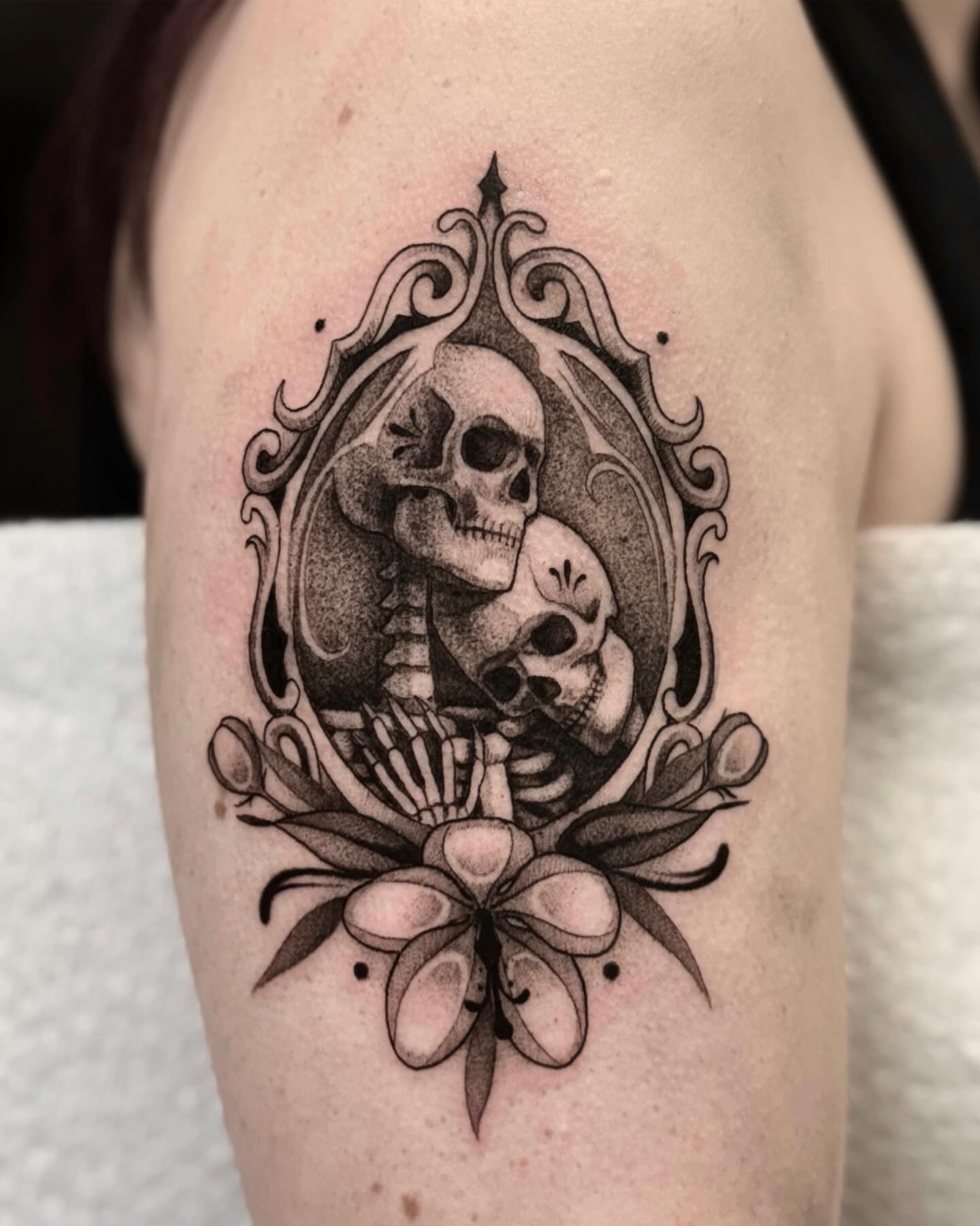 Skulls and floral ornamental tattoo on the shoulder by jada
