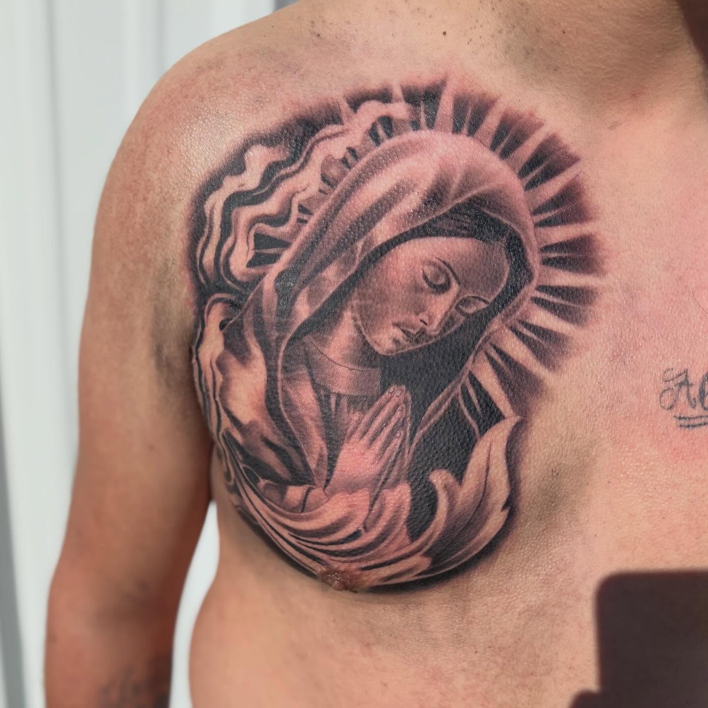 Religious figure praying realism tattoo on the shoulder by Devin