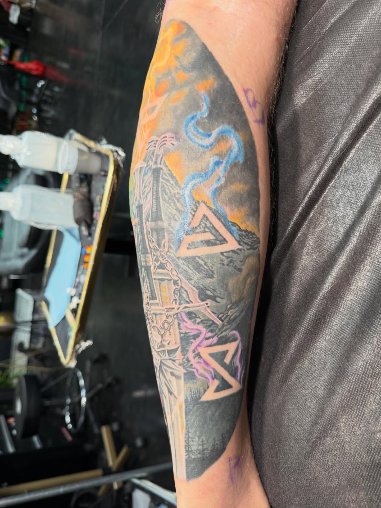 Pyramid and tower geometric tattoo on the forearm by InkFloyd Roith