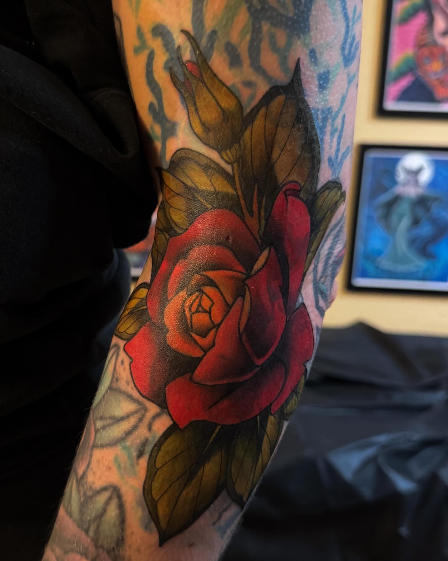 Red rose American traditional tattoo on the forearm by Monica Amneus