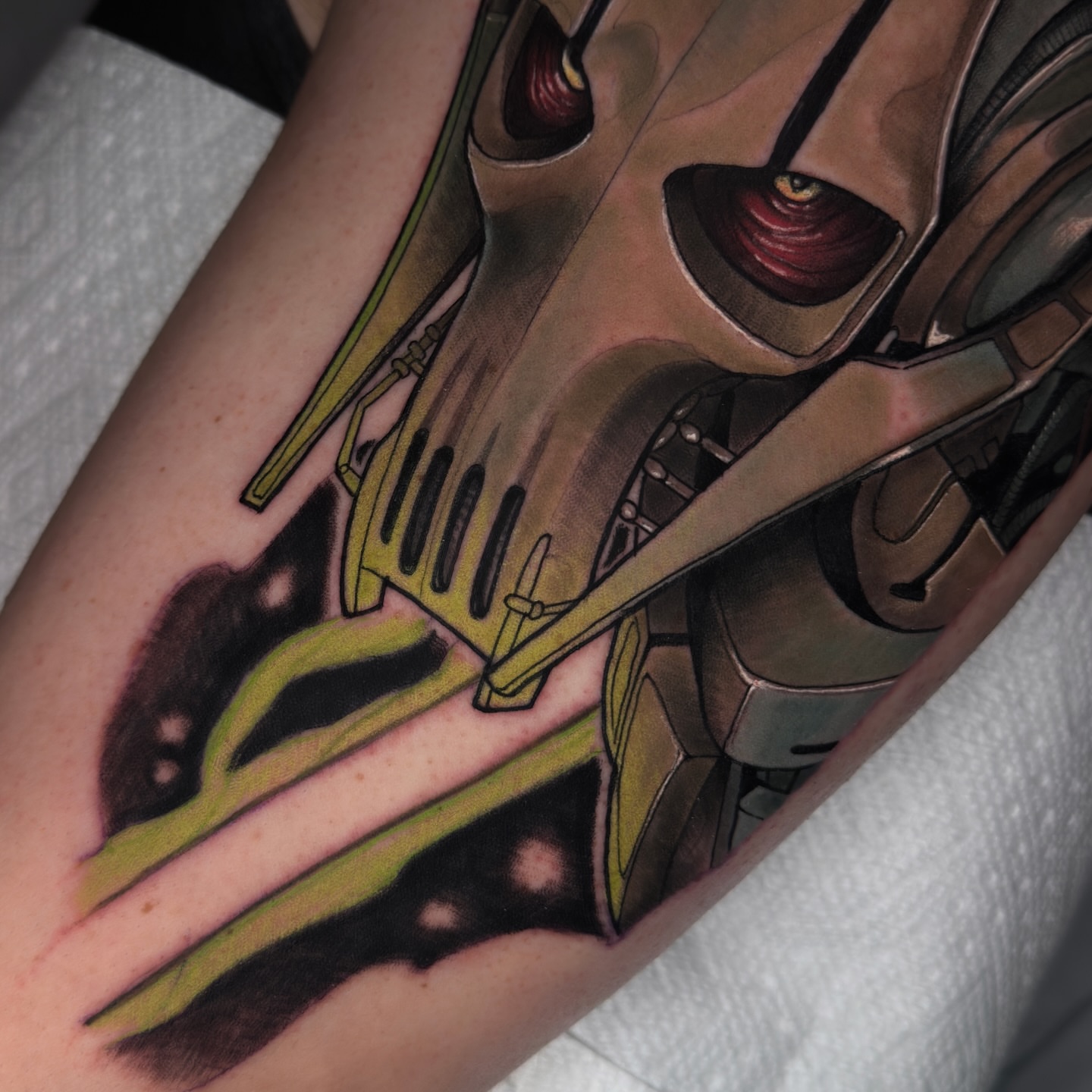 Mecha helmet realism tattoo on the forearm by Golden Heart Tattoo Co
