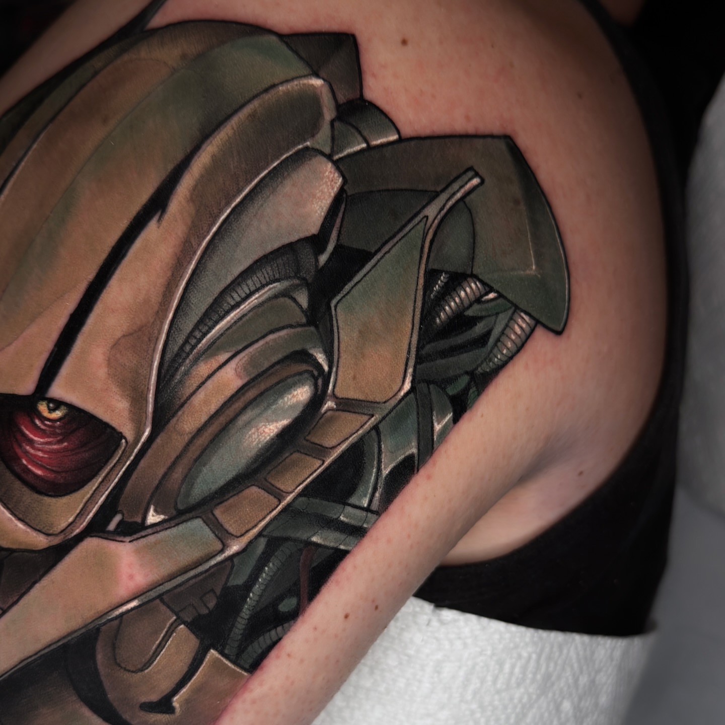 Mecha head geometric tattoo on the shoulder by Golden Heart Tattoo Co
