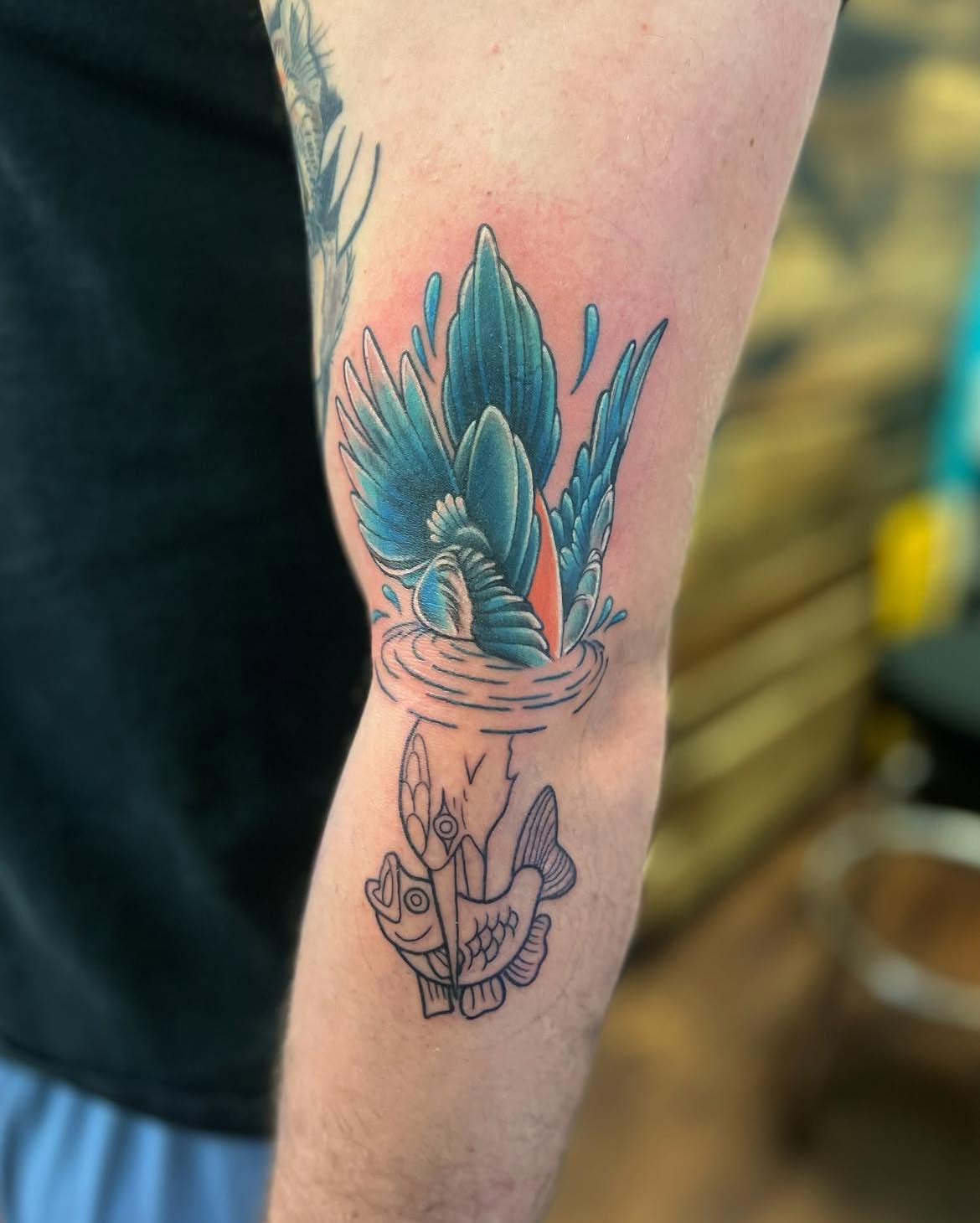 Fish and feathers American traditional tattoo on the forearm by Chelsea Nichole