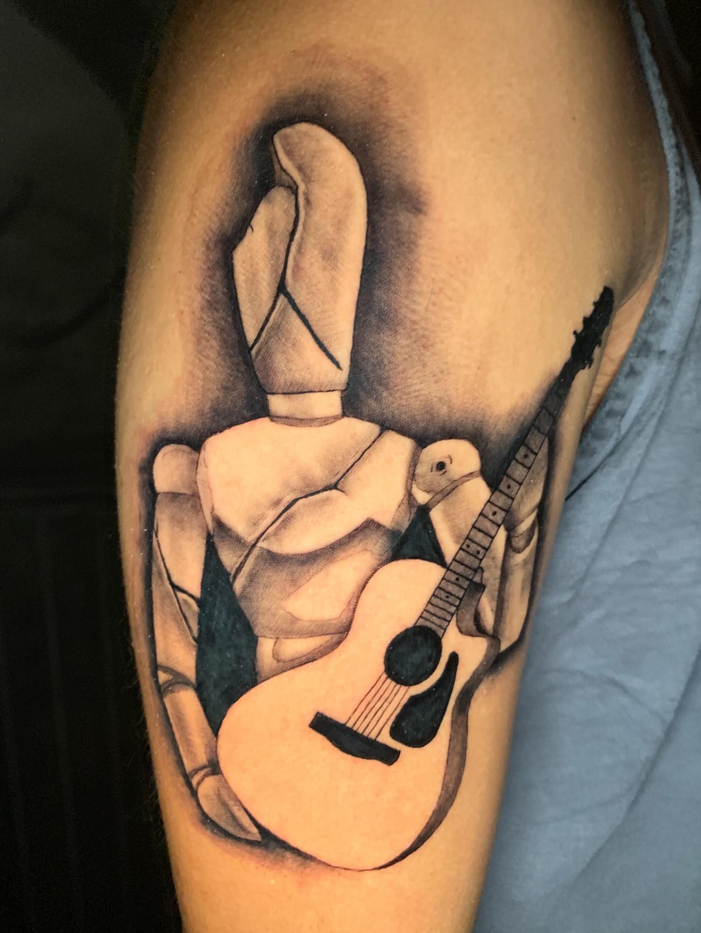 Guitar and hand realism tattoo on the forearm by Devon
