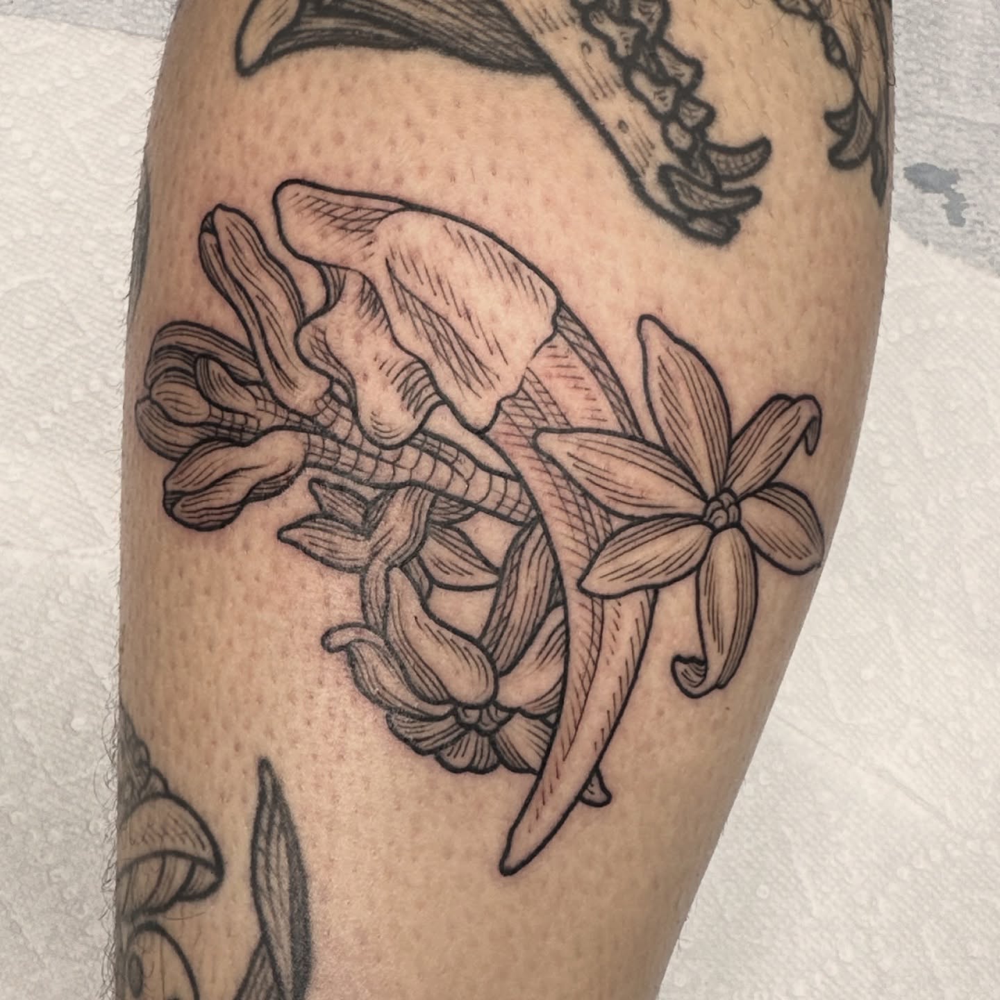 Banana and flower black and grey tattoo on the forearm by Taylor 🍂☕️