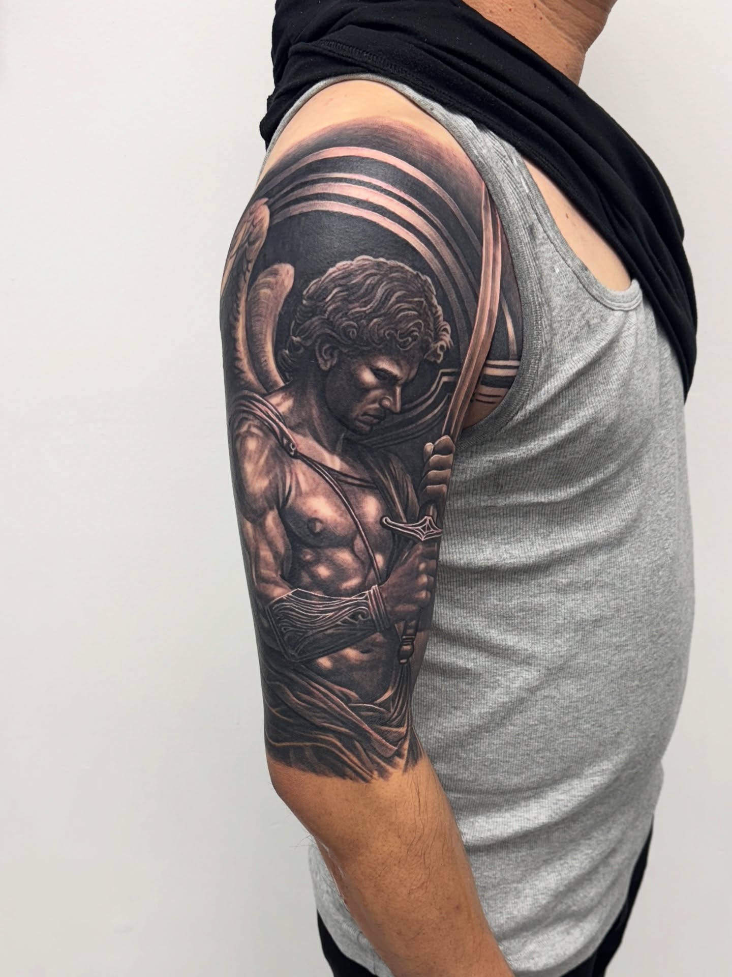 Angel with sword realism tattoo on the upper arm by Anthony Duran