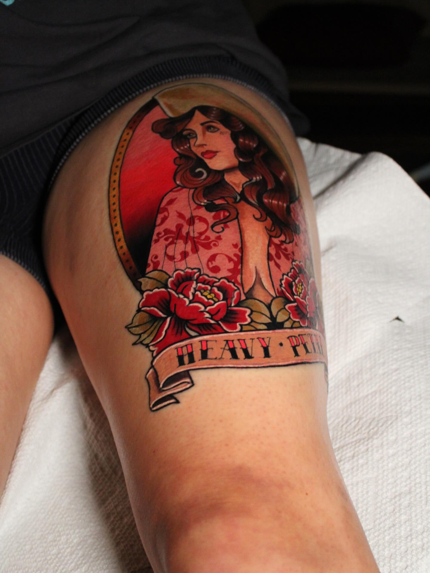 Woman with flowers American traditional tattoo on the thigh by Dylan Walker