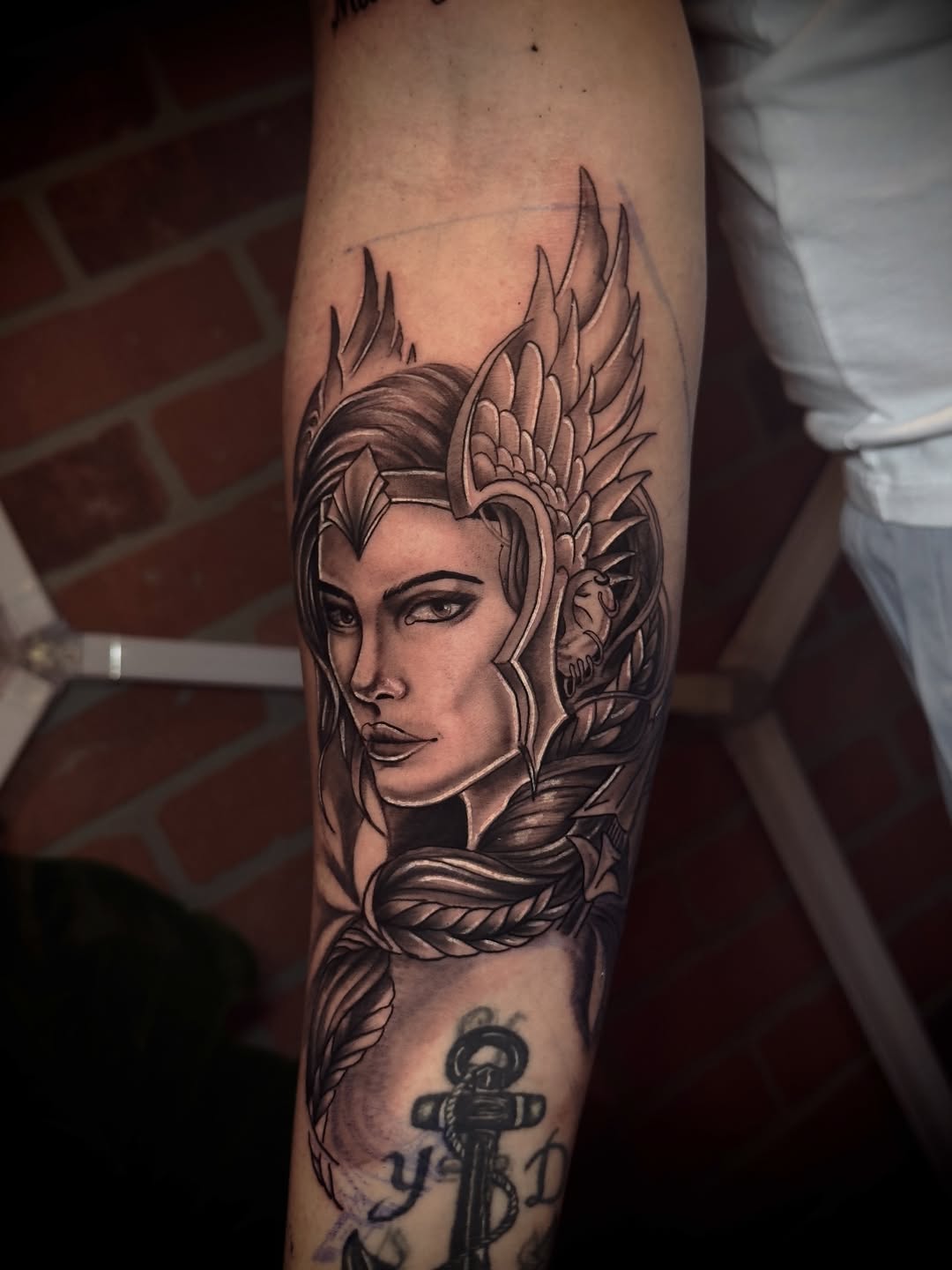 Woman with helmet and braid realism tattoo on the forearm by Andres Calvo🇺🇸🇨🇴
