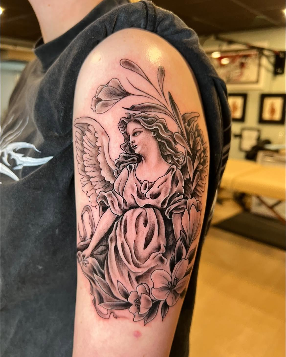 Angel with flowers realism tattoo on the forearm by Jessica Kloos
