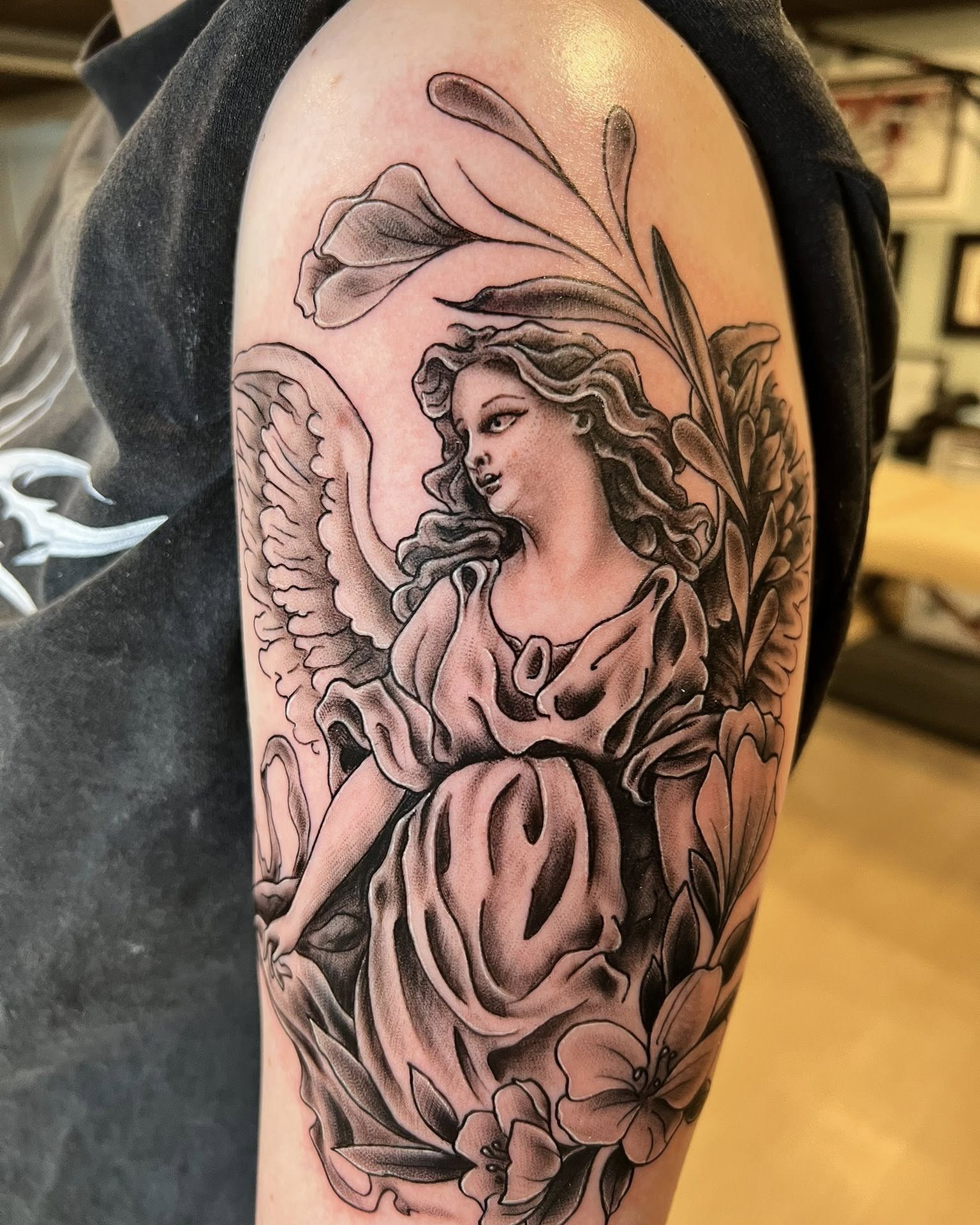 Angel with flowers realism tattoo on the forearm by Jessica Kloos