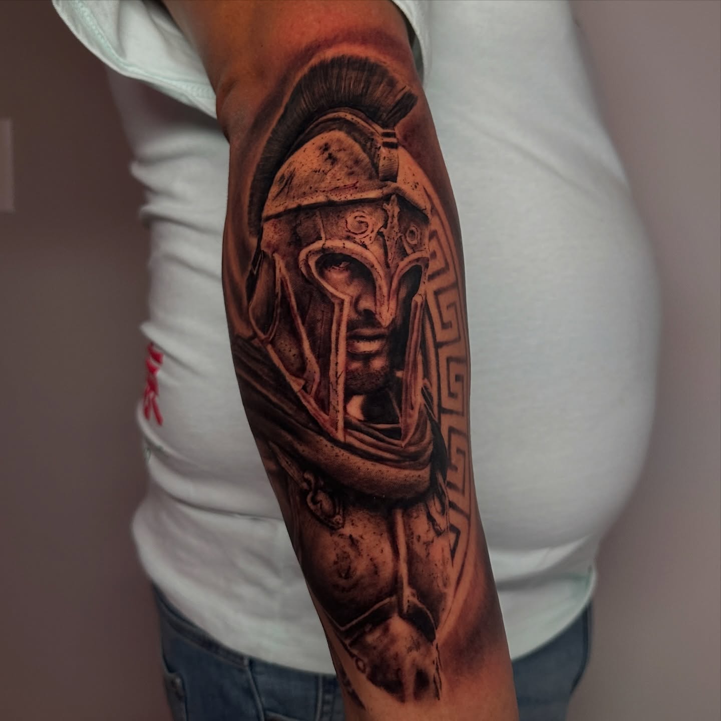 Spartan warrior helmet realism tattoo on the forearm by Dennis Alejandro