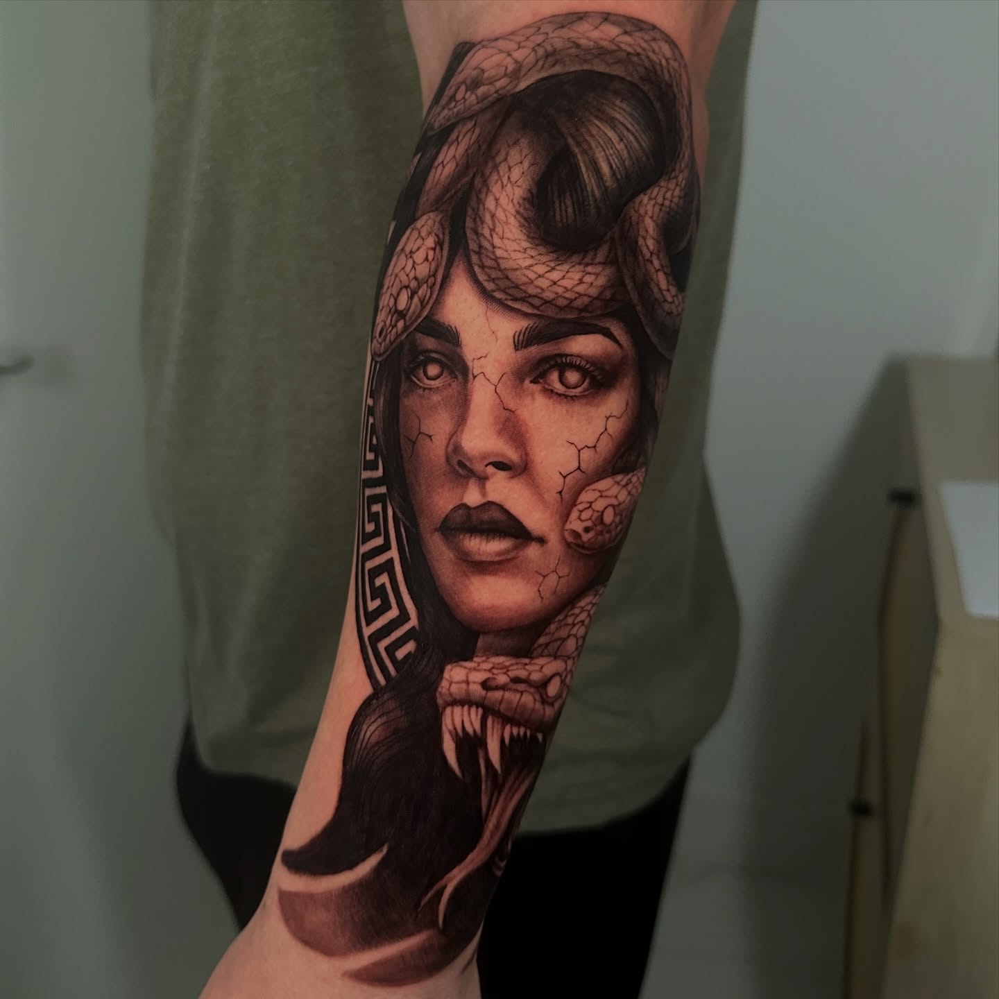Woman's face with snakes realism tattoo on the forearm by Dennis Alejandro