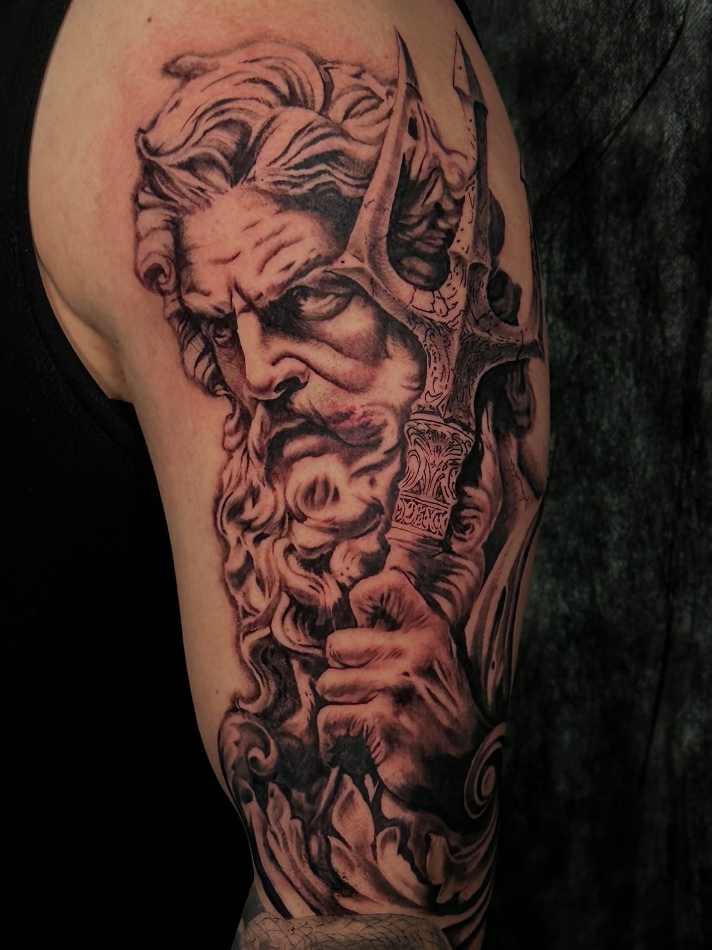 God-like figure realism tattoo on the upper arm by Dennis Alejandro
