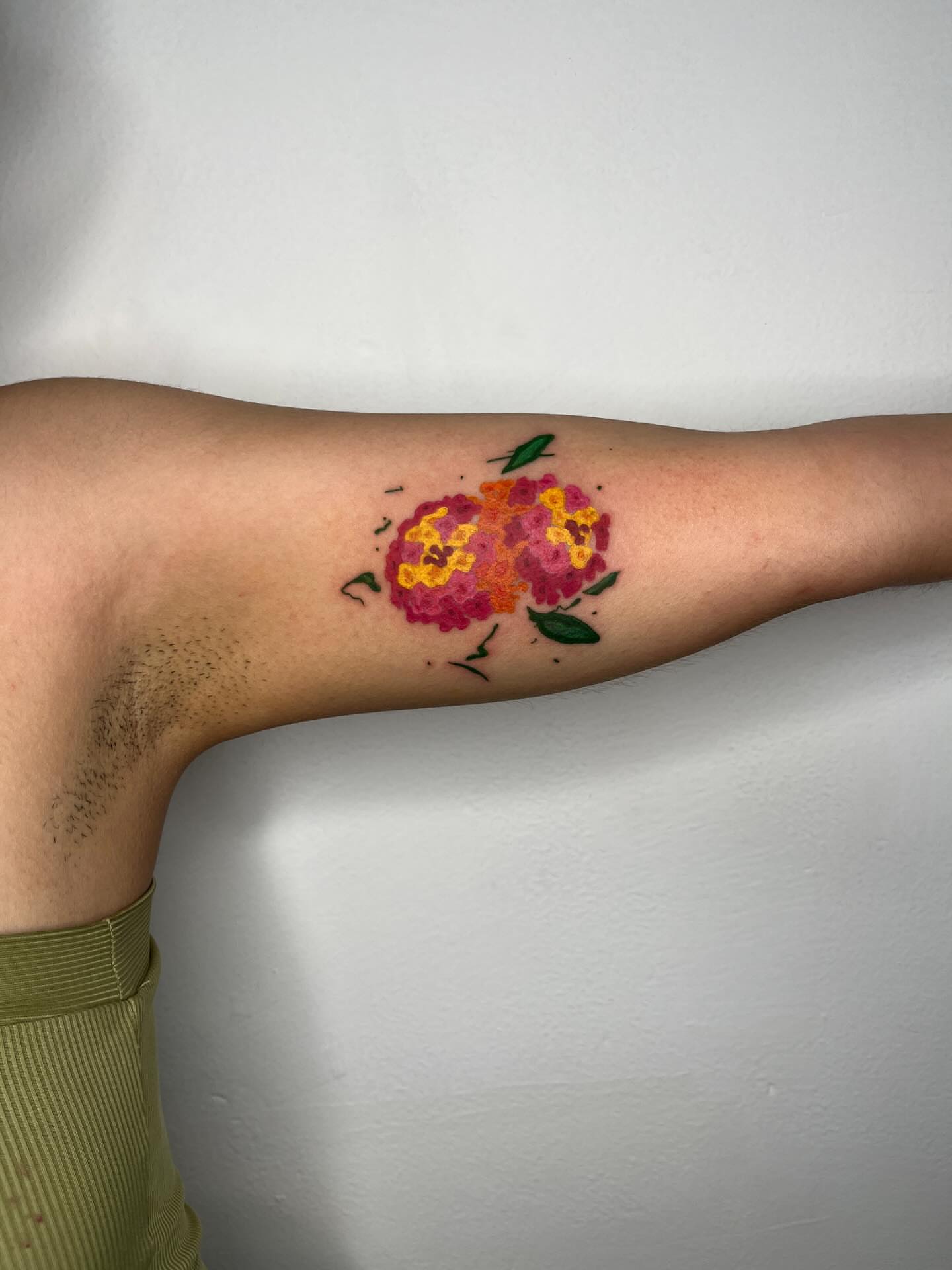 Flowers watercolor tattoo on the forearm by tattoos by quin