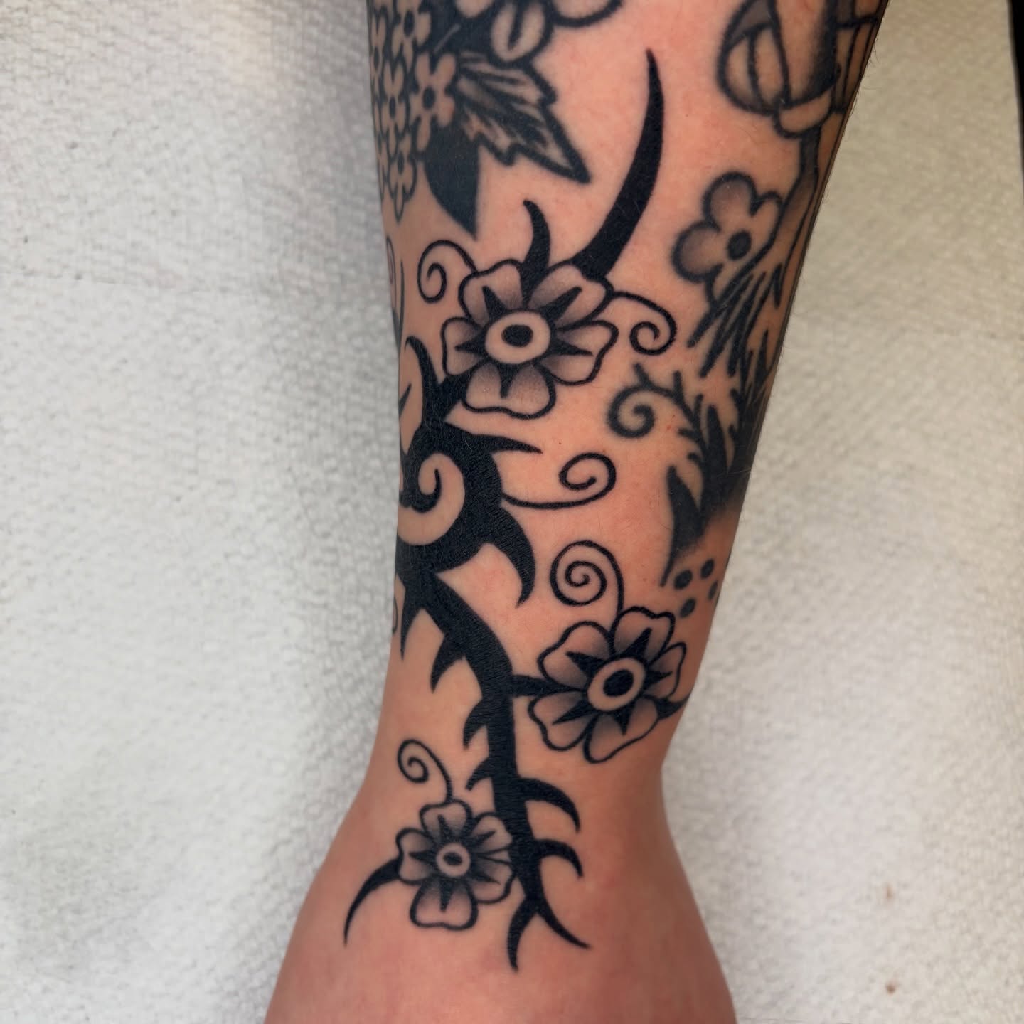 Floral vine black and grey tattoo on the forearm by rachael