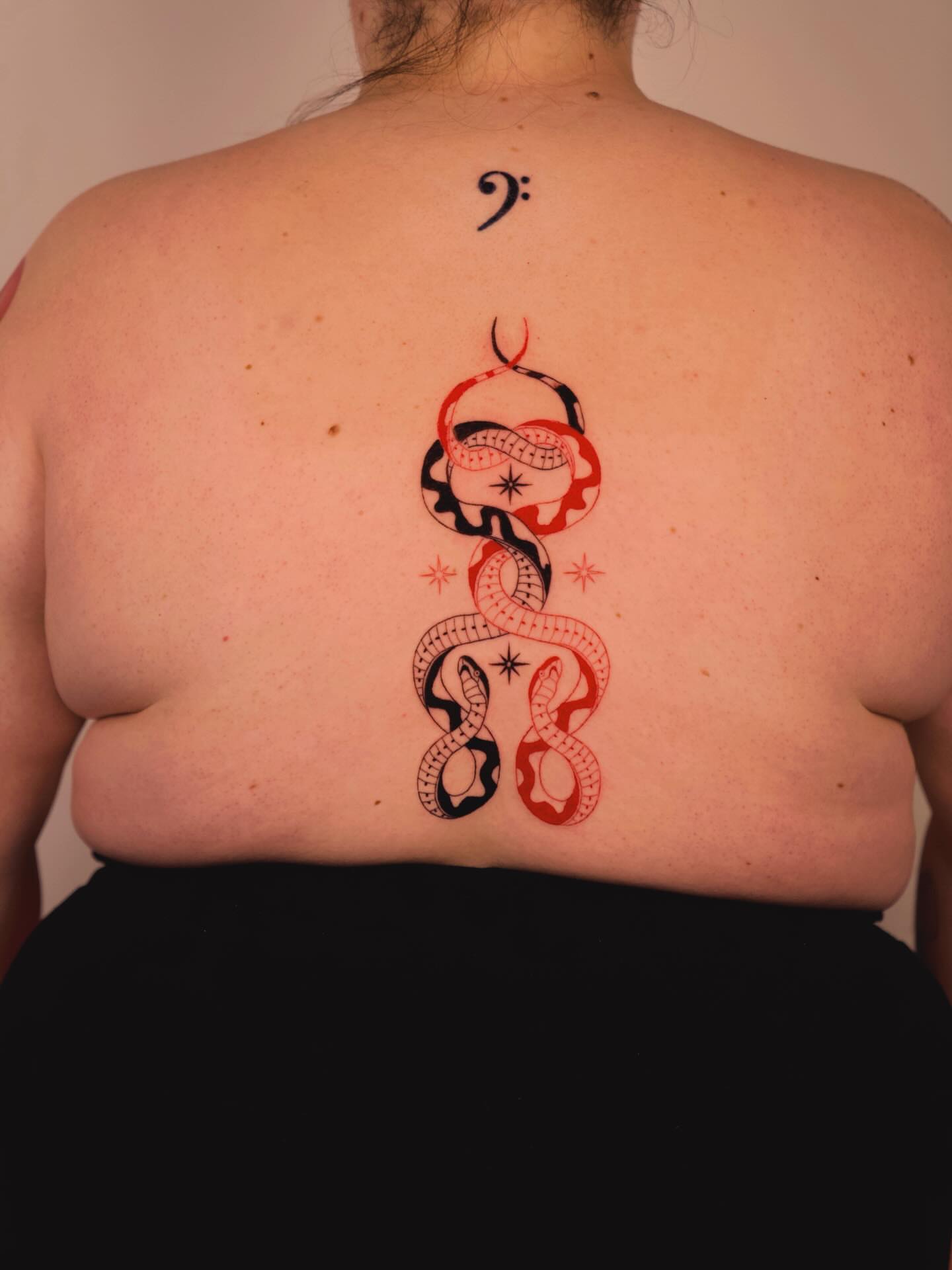 Snake and musical symbol geometric tattoo on the back by b i l l i e, Seattle, Washington