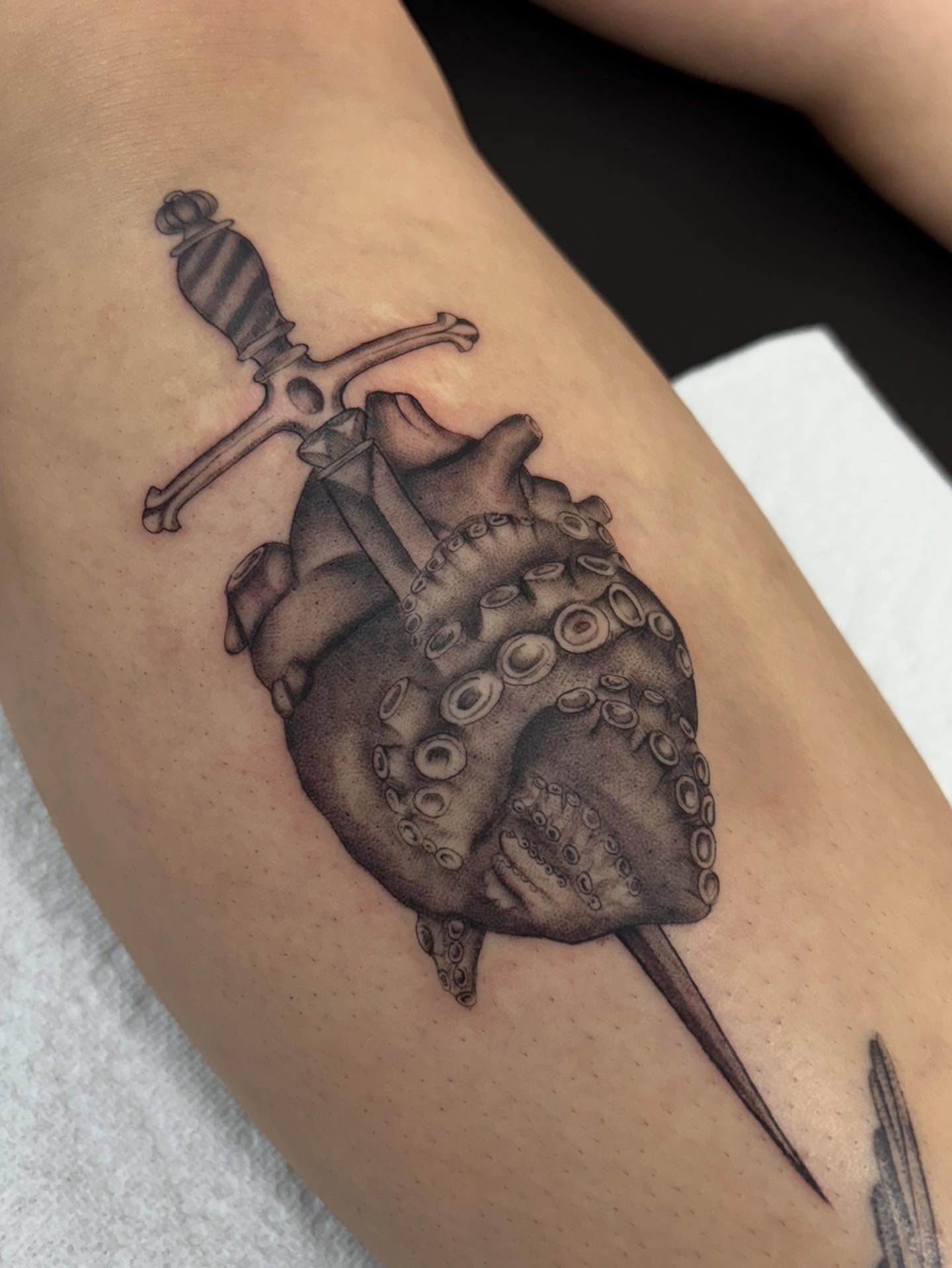 Heart with octopus tentacles dotwork tattoo on the forearm by Jackie π€